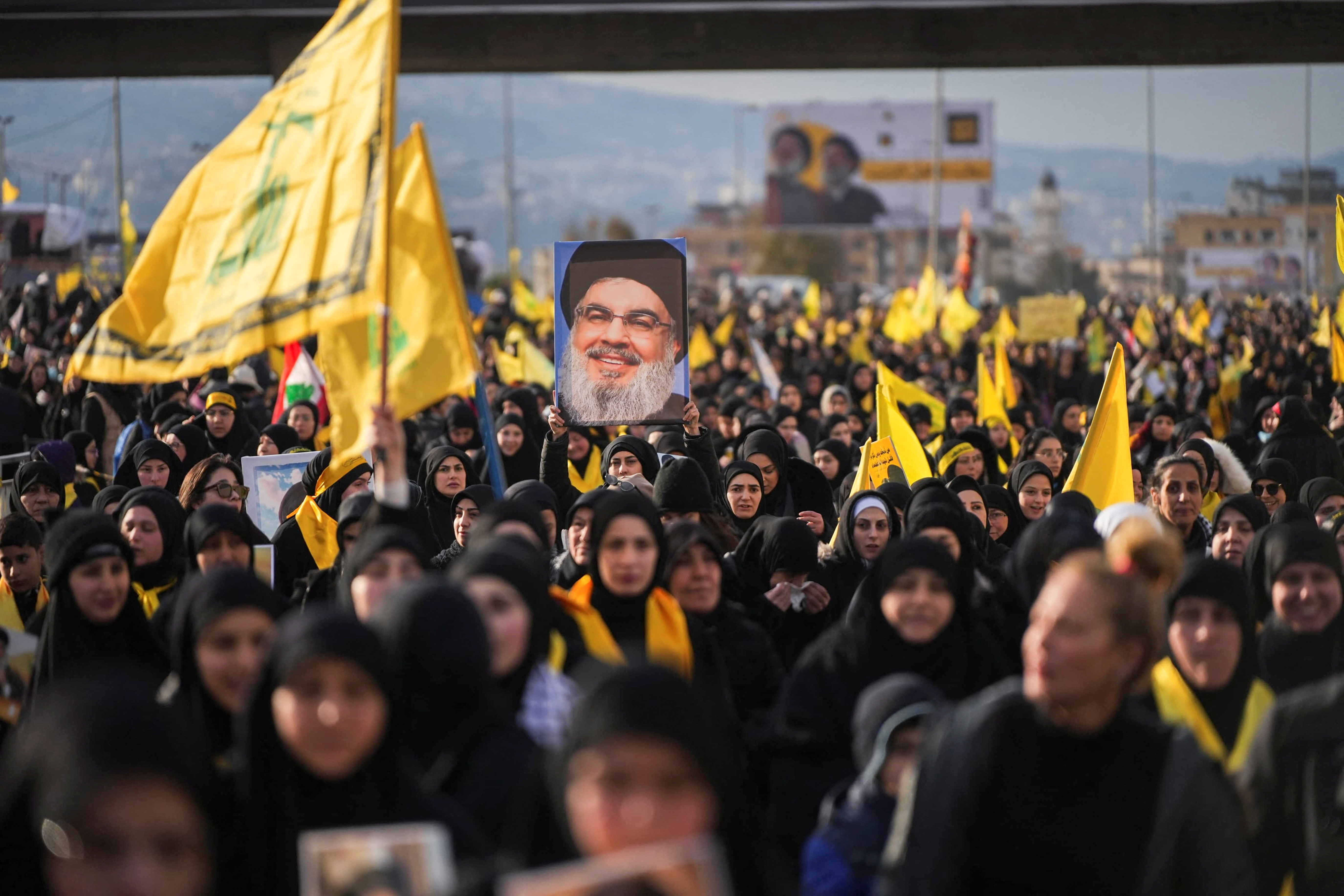 A person holds up a picture of late Hezbollah leader Hassan Nasrallah, who was killed in Israeli airstrikes last year, on the day of a public funeral ceremony in Beirut, Lebanon February 23, 2025. REUTERS/Mohammed Yassin