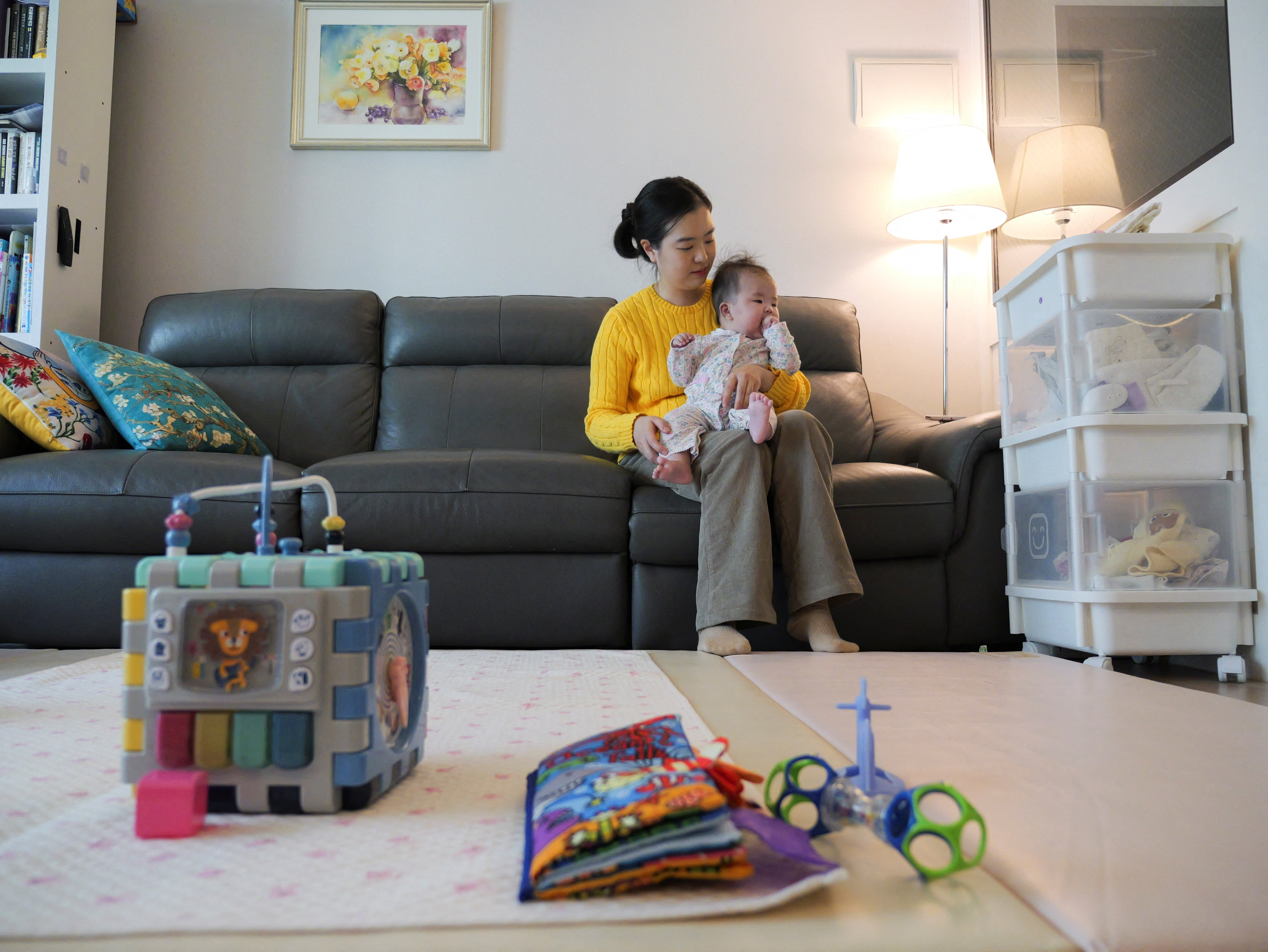 Nam Hyun-jin takes care of her baby at her home in Seoul