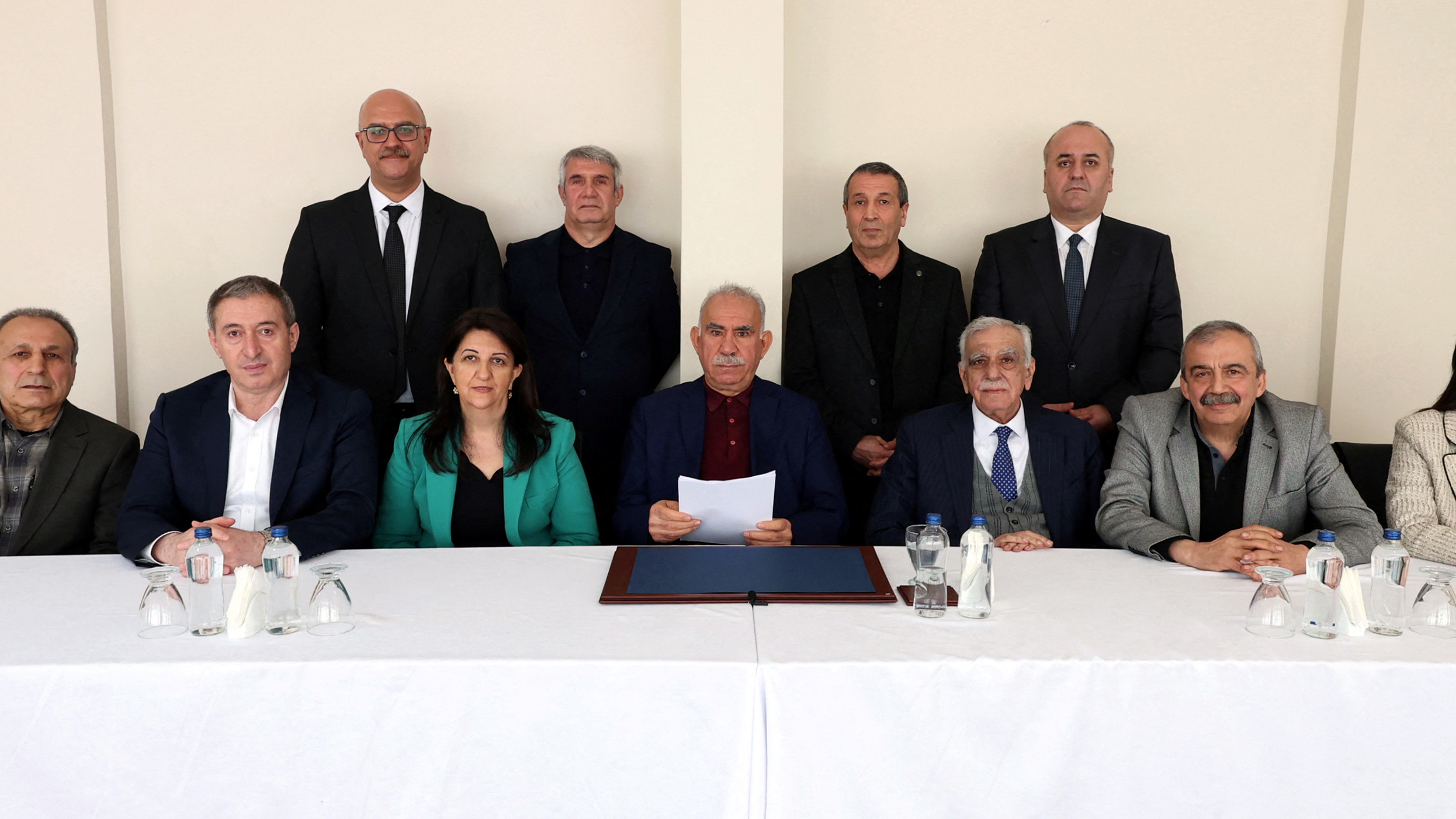 Abdullah Ocalan, the jailed leader of the outlawed Kurdish militant group PKK, is seen with politicians and lawmakers of the pro-Kurdish Peoples' Equality and Democracy Party (DEM Party) Ahmet Turk, Pervin Buldan, Sirri Sureyya Onder, Tulay Hatimogullari, Tuncer Bakirhan, Cengiz Cicek and Faik Ozgur Erol, in Imrali Island prison, in Marmara Sea, in Turkey, February 27, 2025. [Peoples' Equality and Democracy Party Handout via Reuters]