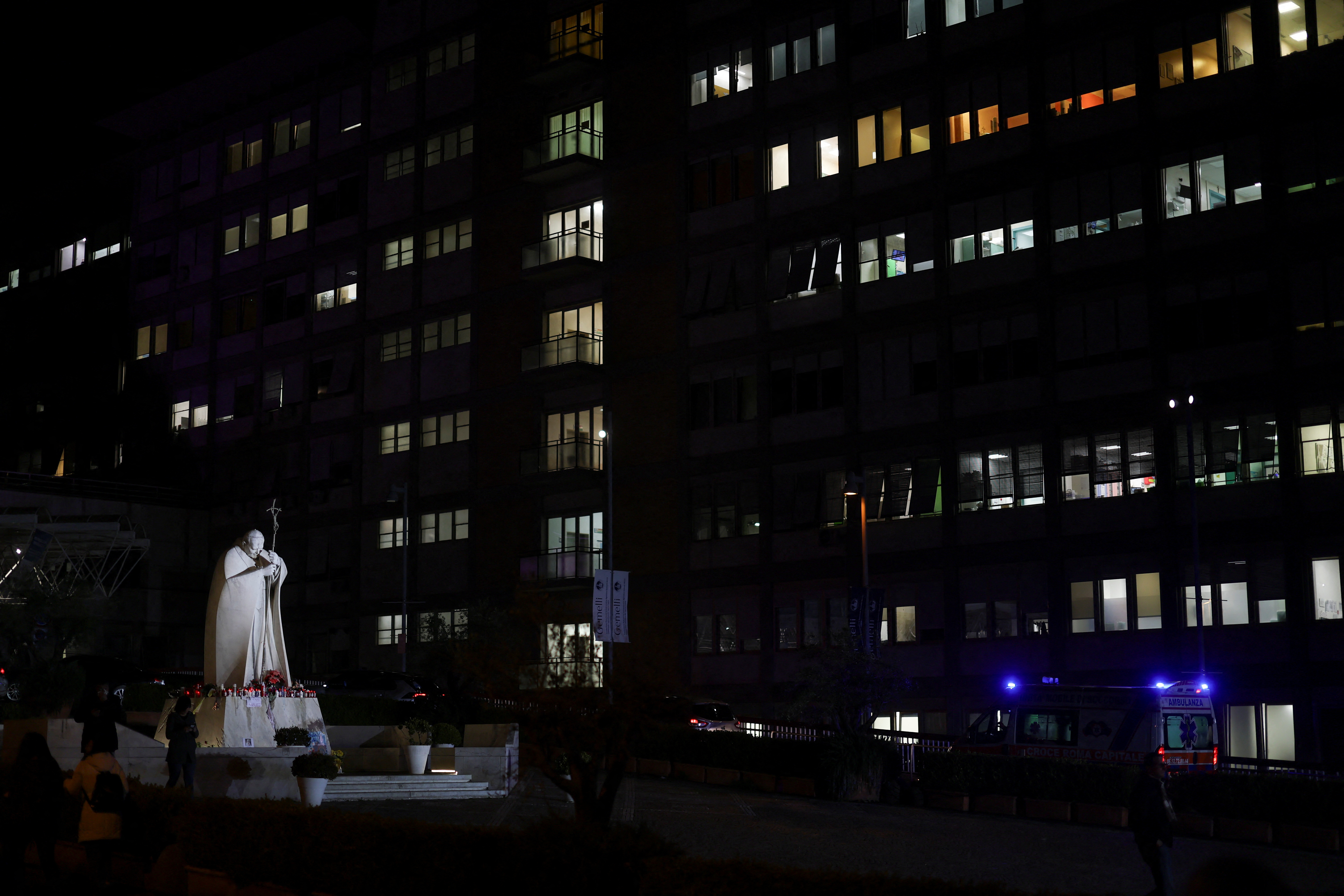 The statue of late Pope John Paul II stands outside the Gemelli Hospital, where Pope Francis is admitted for treatment