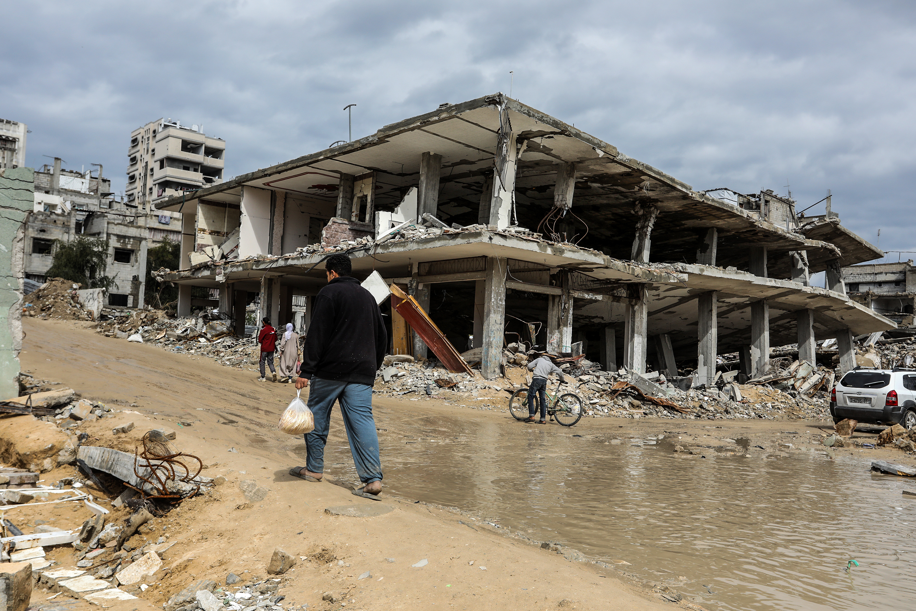 A man walks past a destroyed building in Gaza