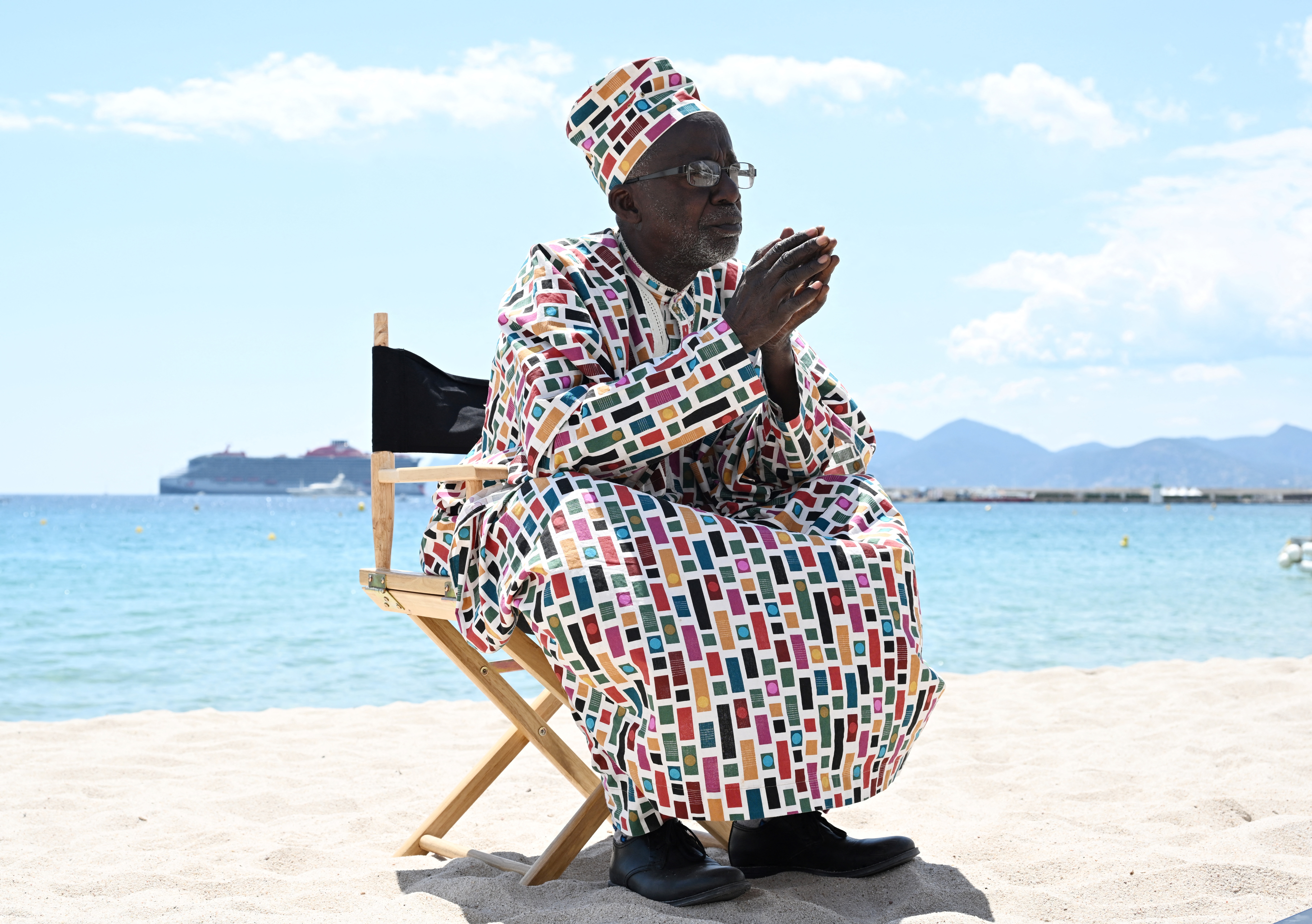 Malian director Souleymane Cisse poses on a beach.
