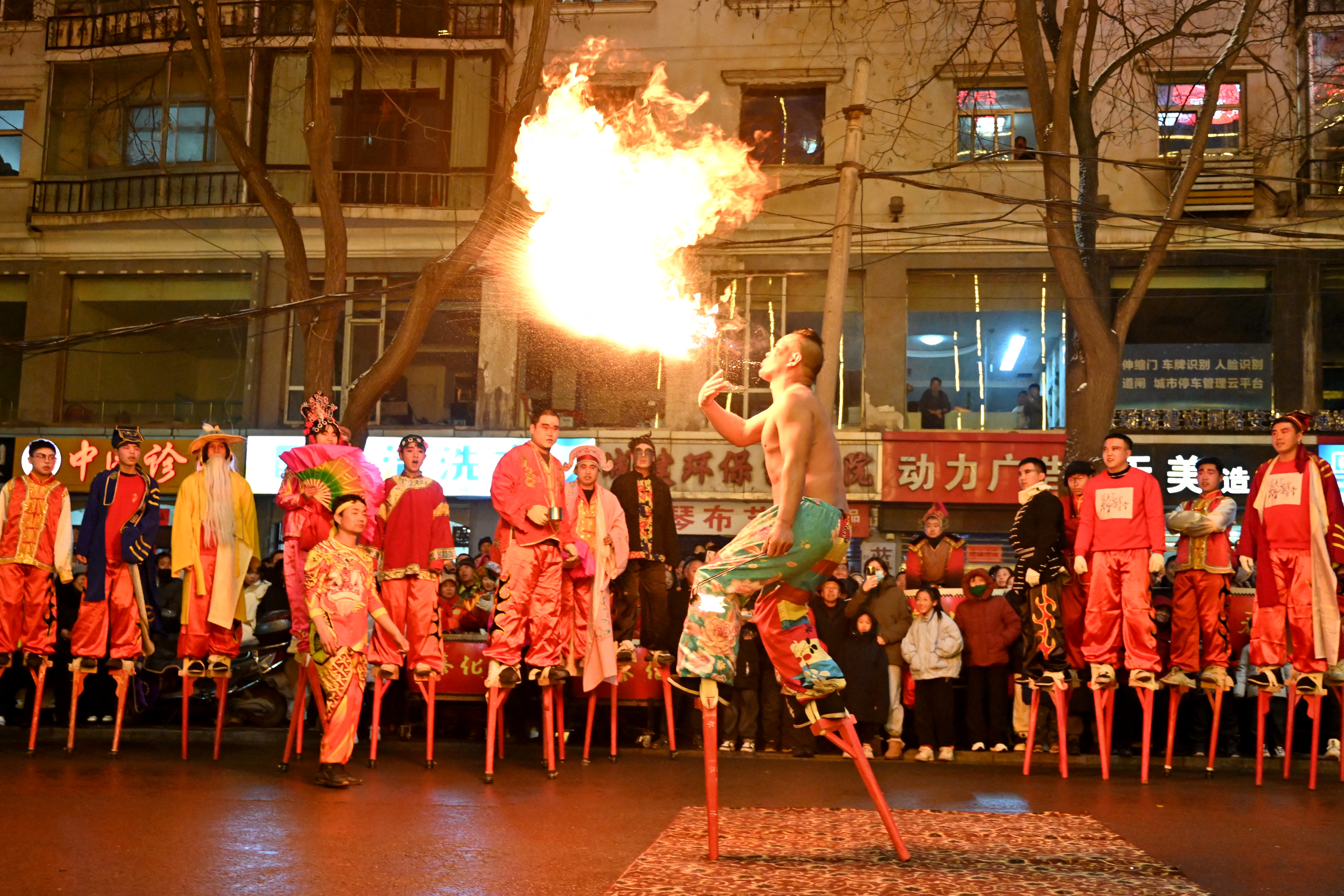 People participate in an art parade to mark lantern festival in Luliang, northern China