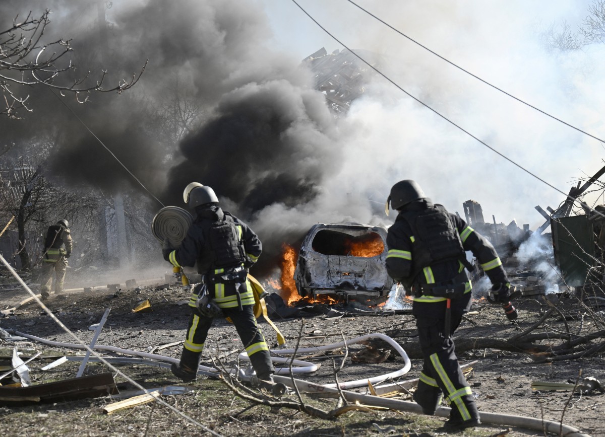 Ukrainian firefighters work at the site of a strike in the city of Kramatorsk