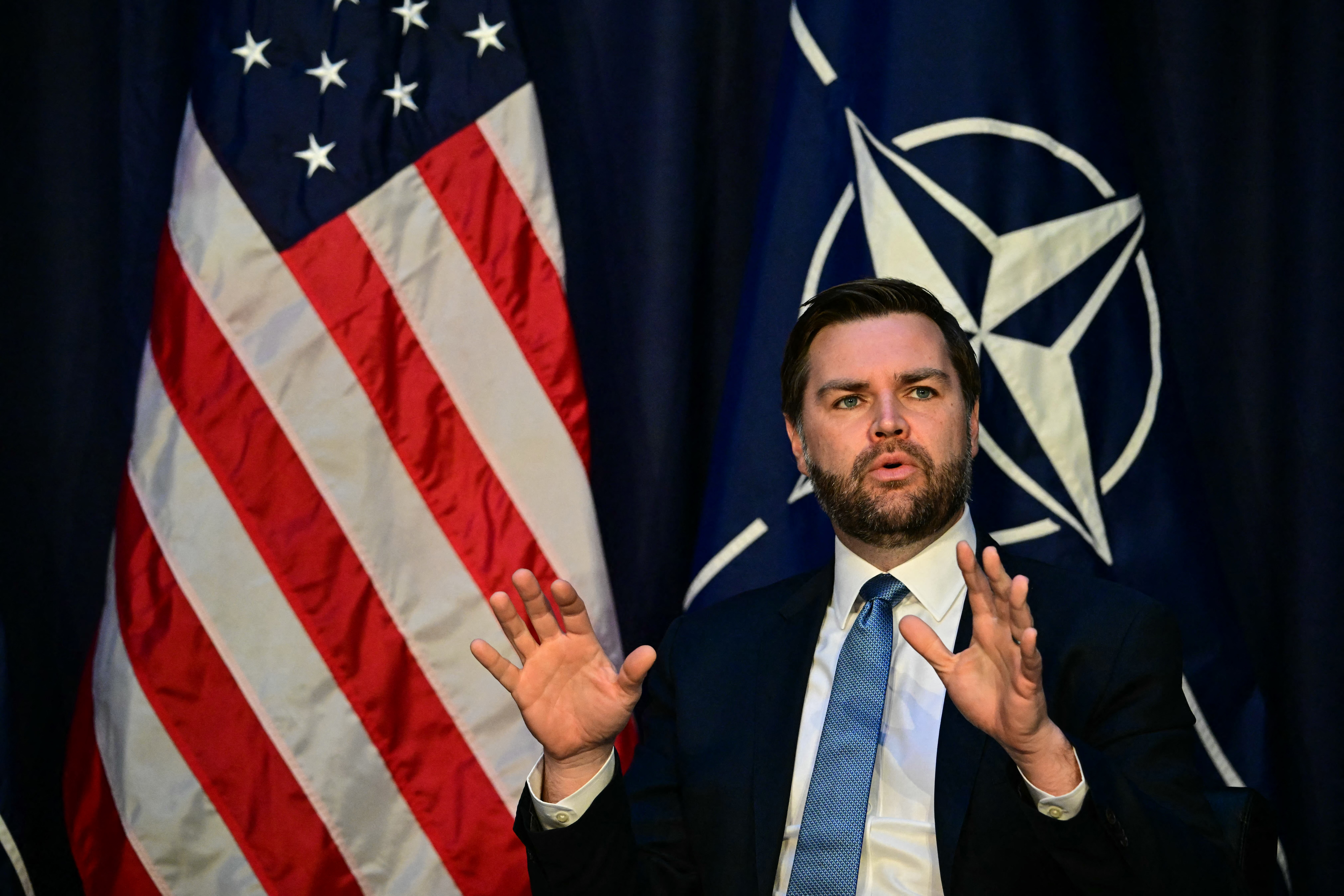 US Vice President JD Vance gestures as he speaks with NATO Secretary General during a meeting on the sidelines of the 61st Munich Security Conference (MSC) in Munich, southern Germany on February 14, 2025. (Photo by Tobias SCHWARZ / AFP)