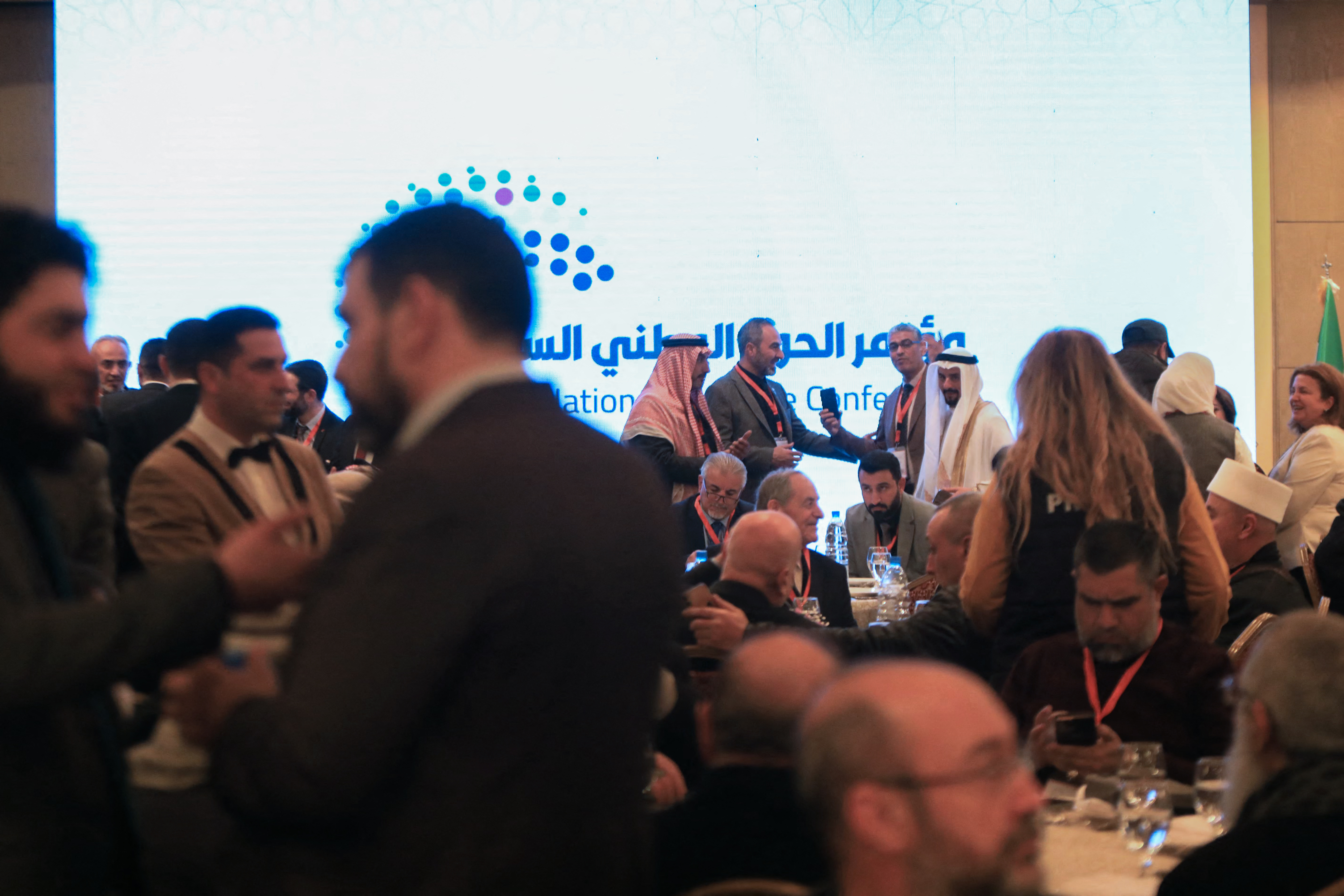 Representatives and dignitaries of Syrian communities attend a conference.