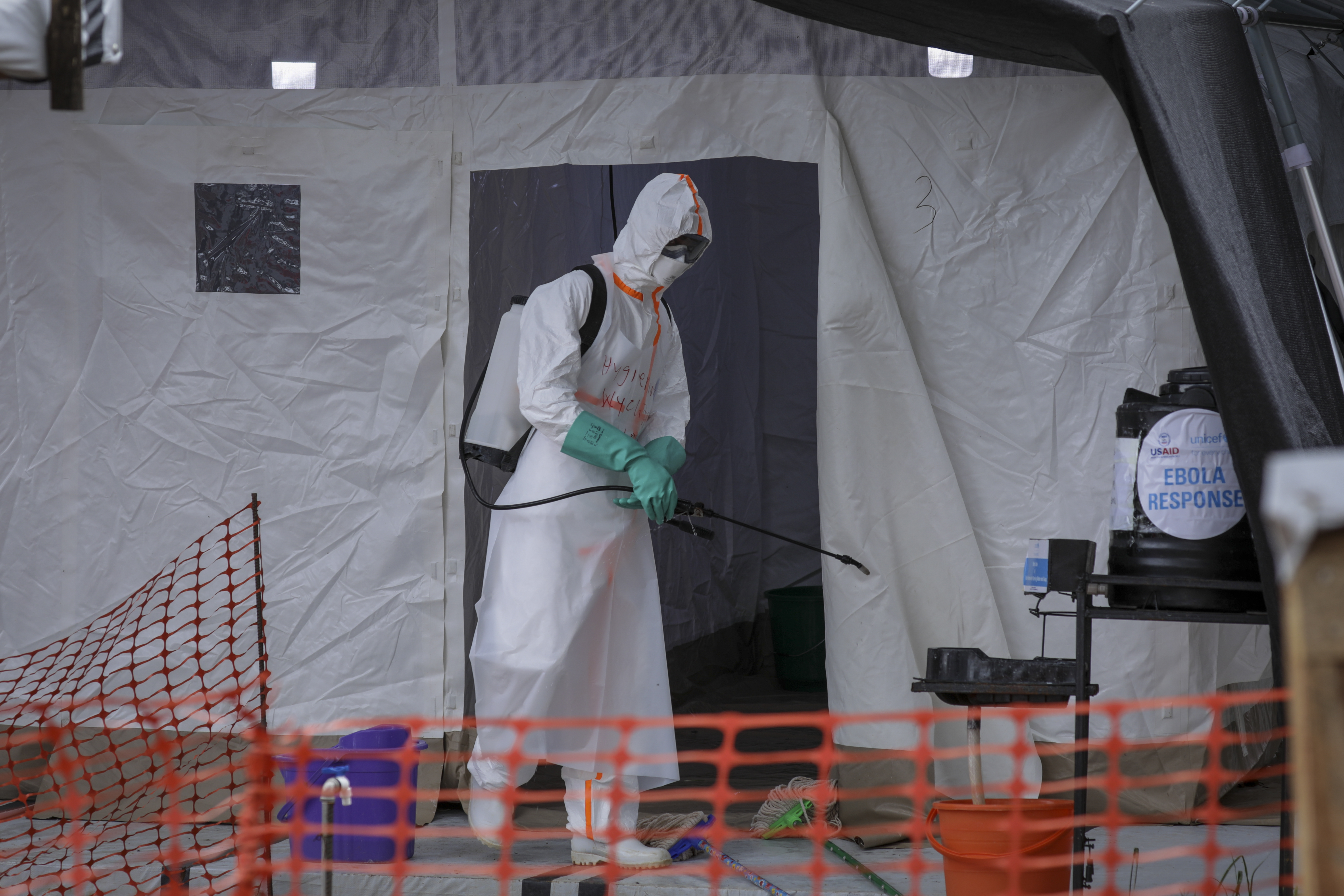 A medical worker disinfects a tent used for suspected Ebola victims.