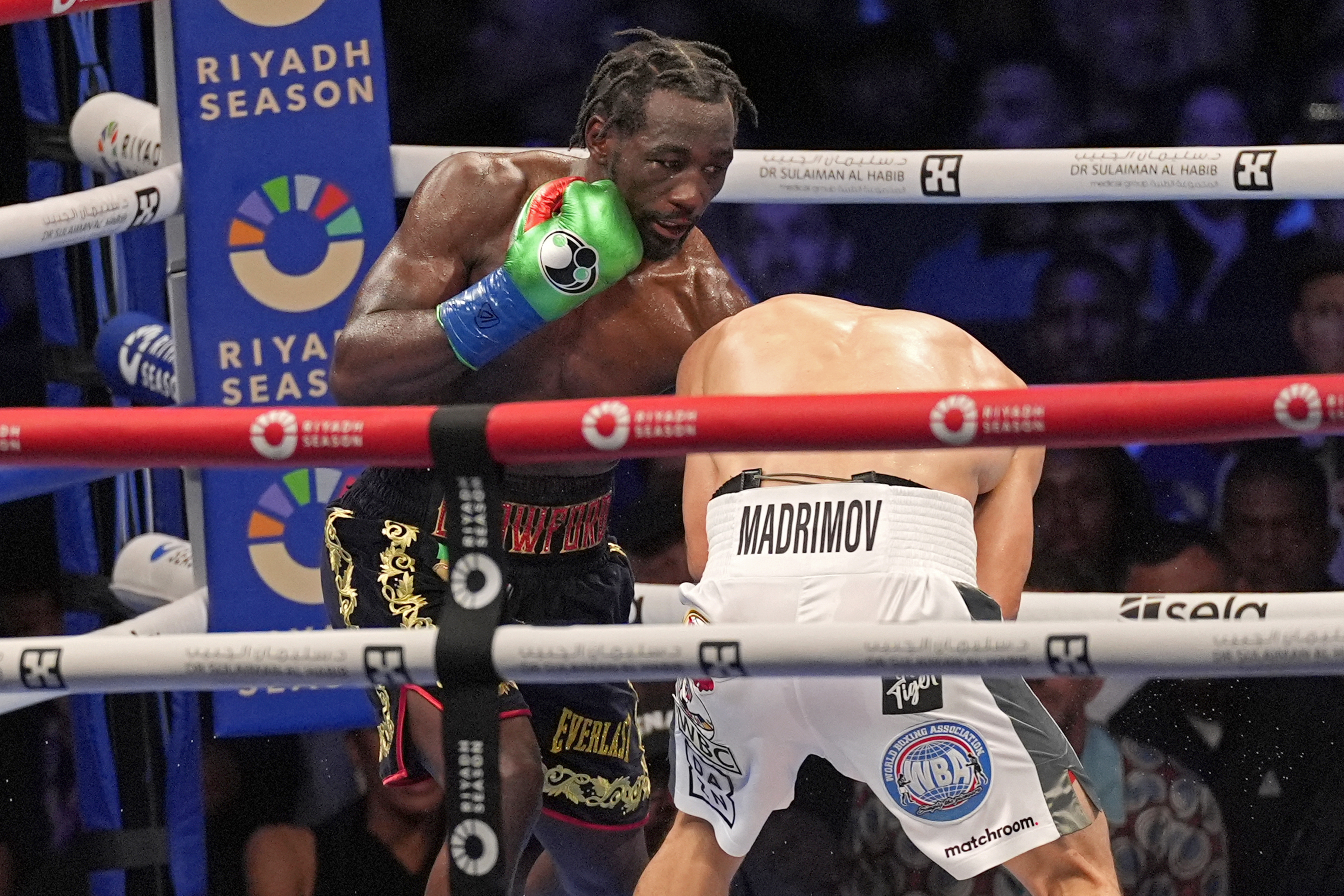 Boxer Terence Crawford, left, fights against Israil Madrimov during a super welterweight championship boxing match in Los Angeles, Saturday, Aug. 3, 2024. Crawford, the consensus best pound-for-pound boxer in the world, defeated Madrimov by unanimous decision to become a four-division champion. (AP Photo/Damian Dovarganes)