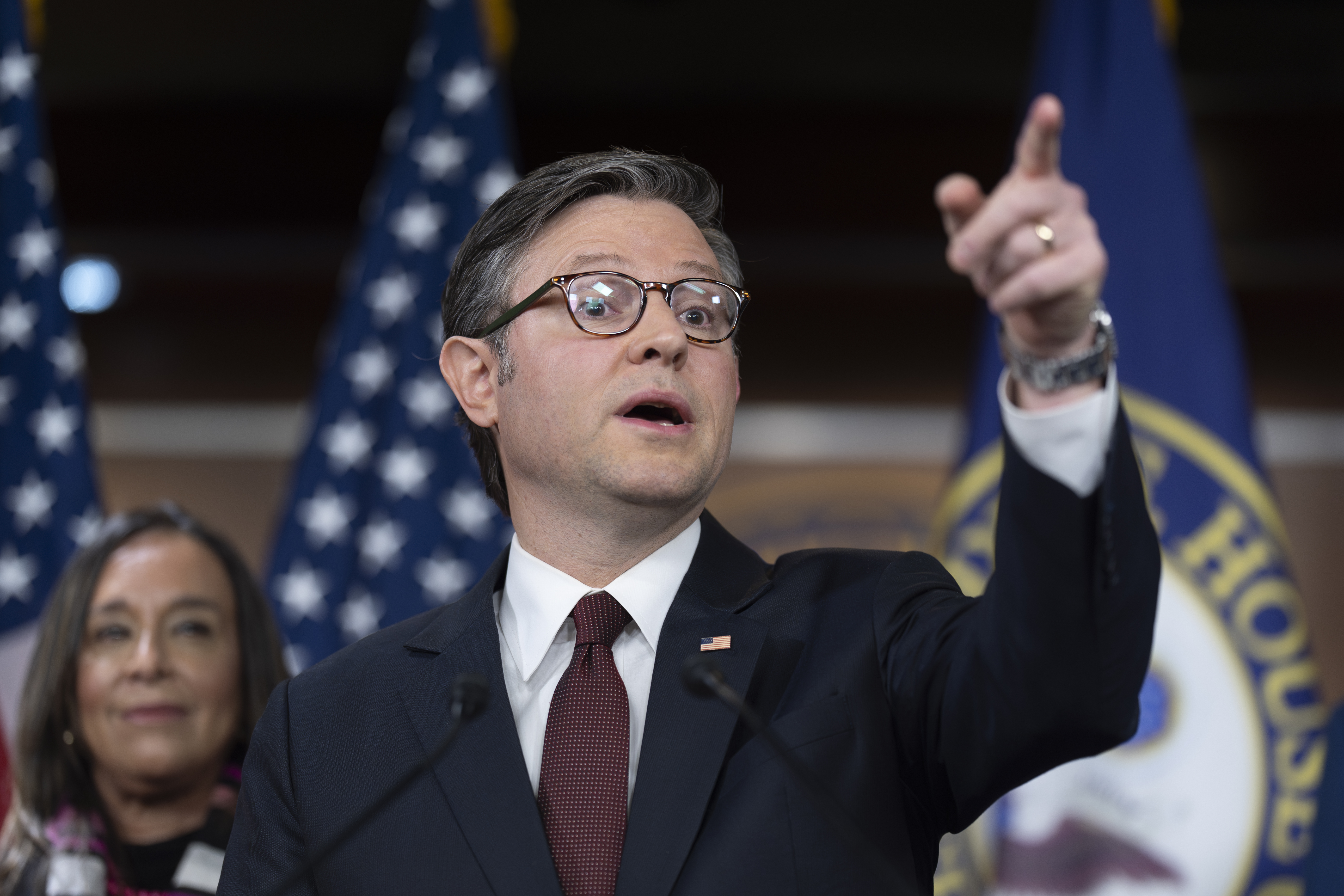 Mike Johnson points at a press conference