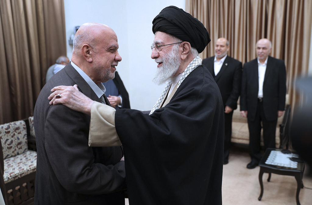 Supreme Leader Ayatollah Ali Khamenei greets Nizar Awadallah, a member of Hamas's leadership council.