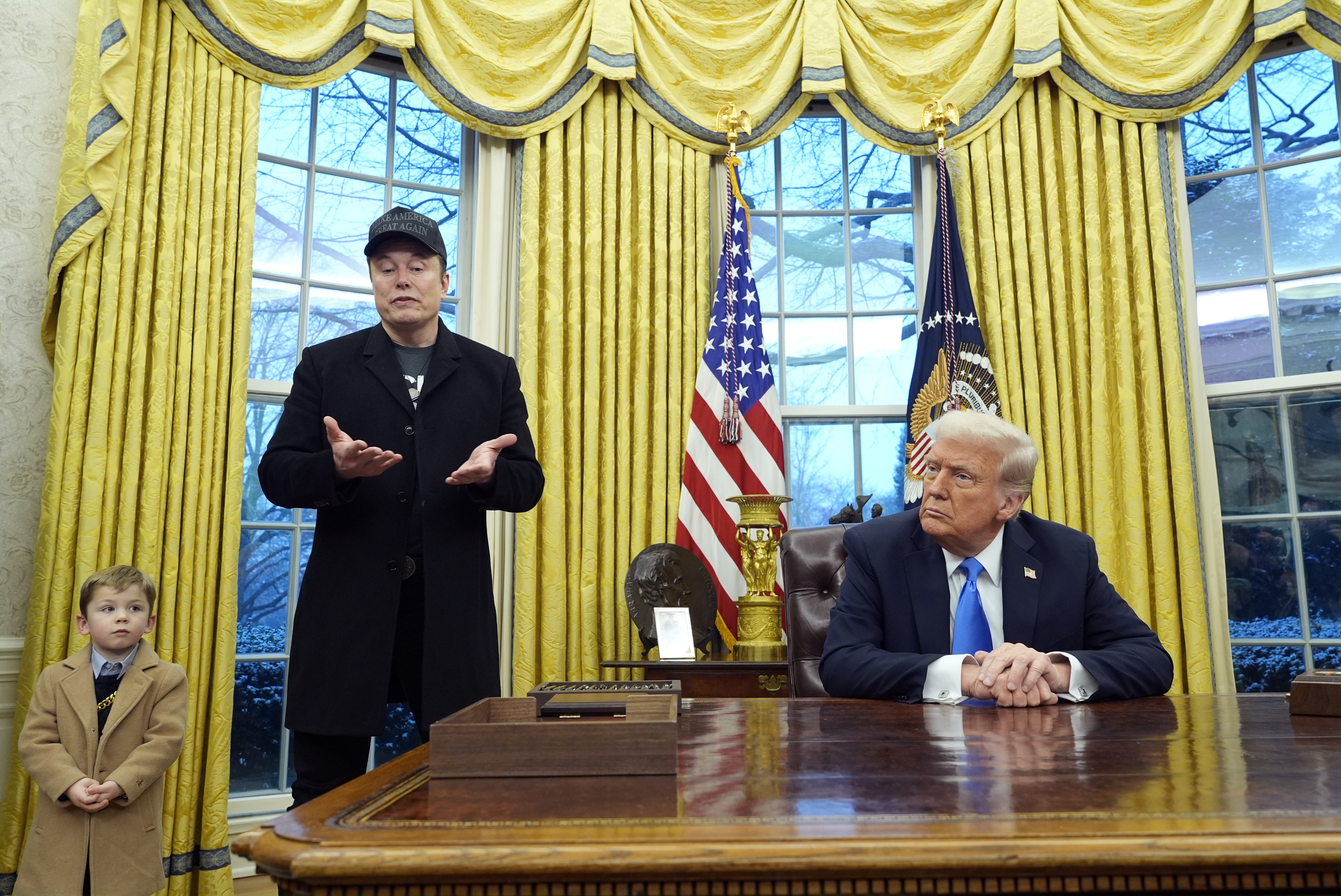 Elon Musk, his child and Donald Trump together in the Oval Office.
