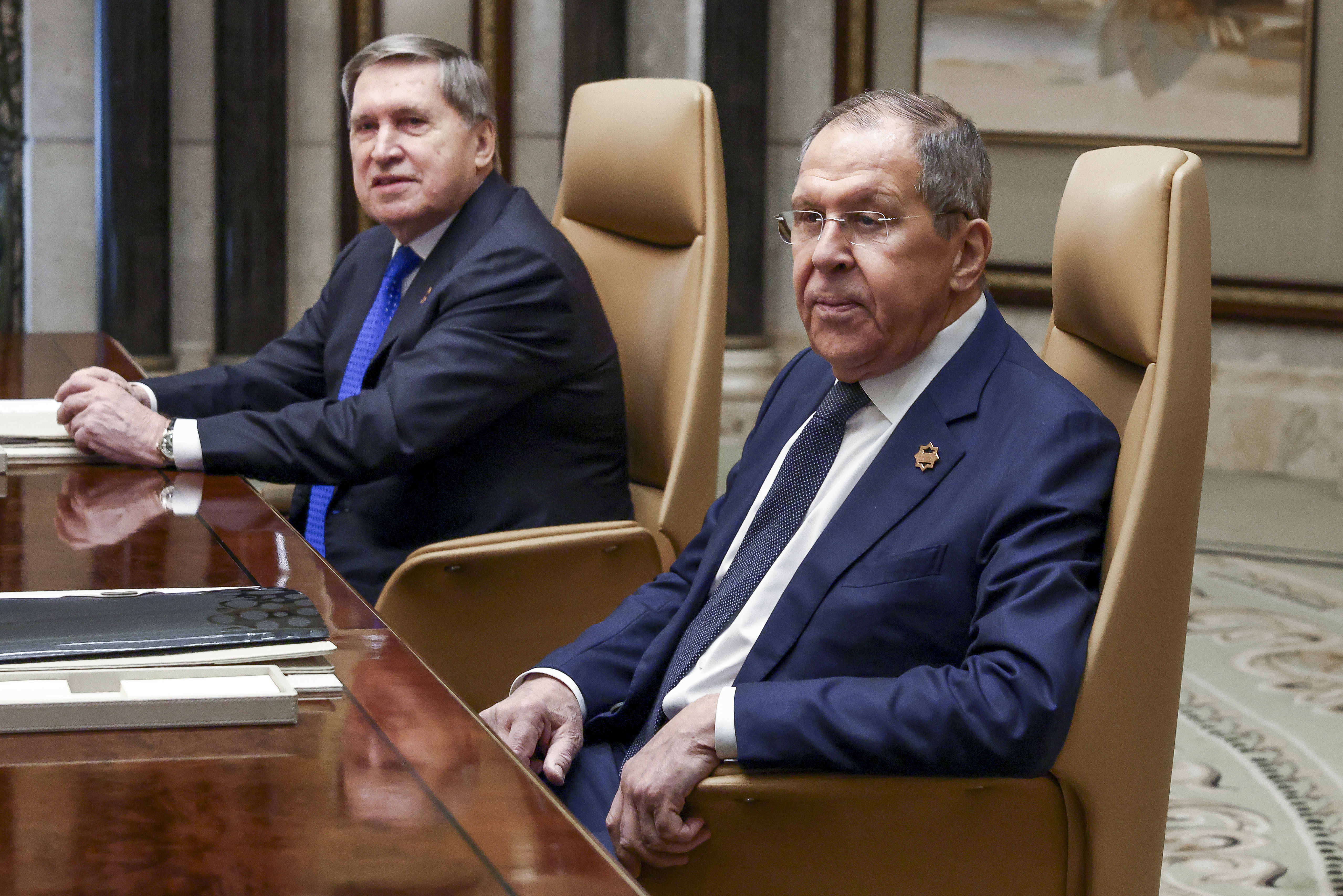 Russian Foreign Minister Sergei Lavrov, right, sits next to Russian President Vladimir Putin's foreign policy advisor Yuri Ushakov during a meeting with U.S. Secretary of State Marco Rubio, U.S. National Security Advisor Mike Waltz and U.S. Middle East envoy Steve Witkoff, Saudi Foreign Minister Prince Faisal bin Farhan Al Saud and Saudi National Security Advisor Mosaad bin Mohammad Al-Aiban, at Diriyah Palace, in Riyadh, Saudi Arabia, Tuesday, Feb. 18, 2025. (Evelyn Hockstein/Pool Photo via AP)