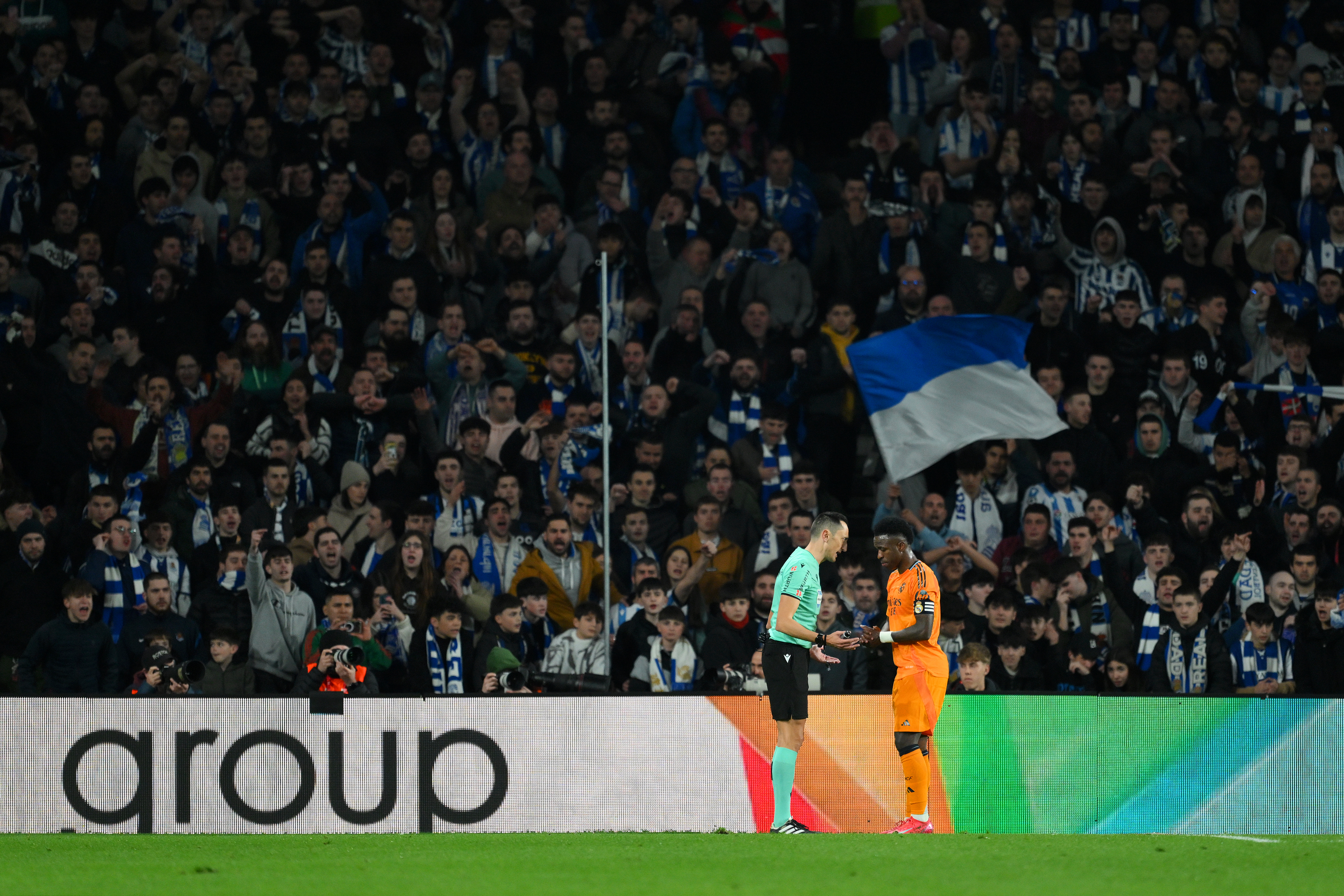 SAN SEBASTIAN, SPAIN - FEBRUARY 26: Vinicius Junior of Real Madrid talks to Referee, Jose Maria Sanchez Martinez in front of Real Sociedad fans during the Copa del Rey Semi Final match between Real Sociedad and Real Madrid at Reale Arena on February 26, 2025 in San Sebastian, Spain. (Photo by David Ramos/Getty Images)