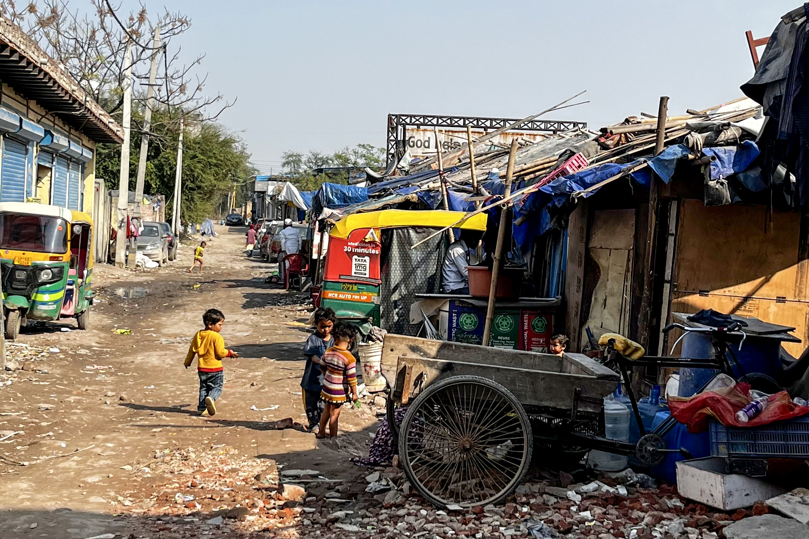Rohingya children play in a refugee settlement in Delhi, where hundreds of families live in makeshift shelters with limited access to water, electricity, and education.