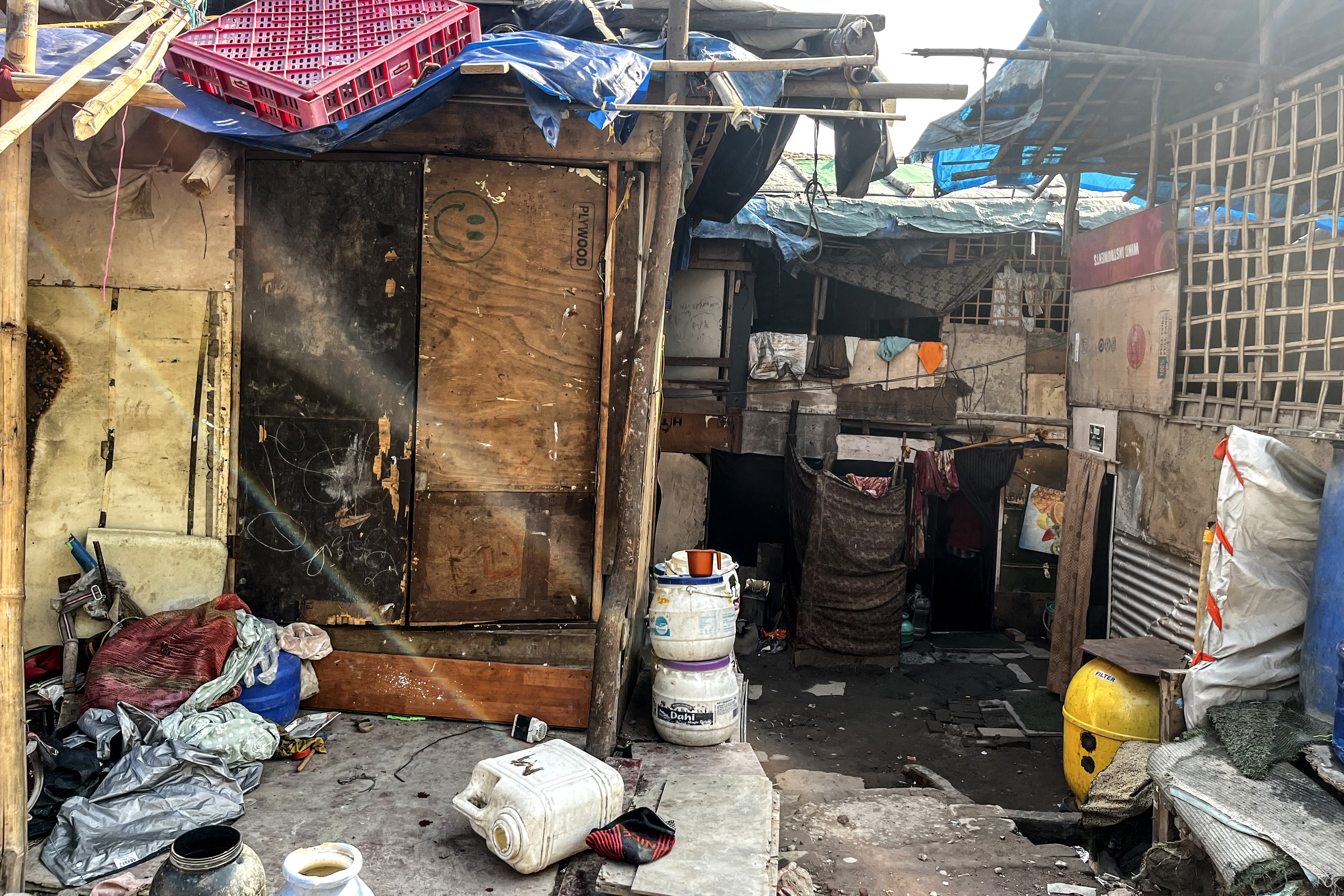Stored water in plastic containers due to a lack of basic amenities.