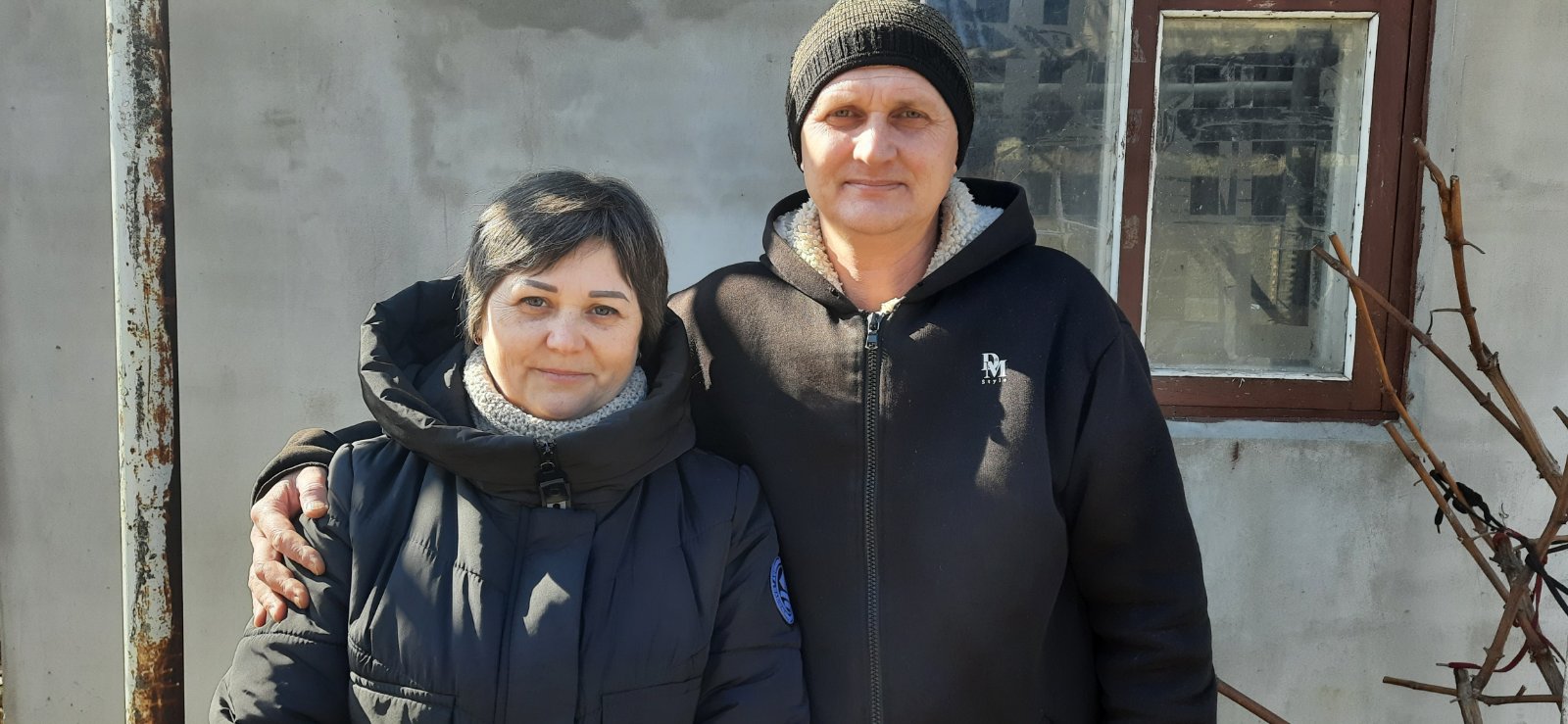 Olha and her husband Dmytro in front of their house in Voznesensk-1740397642