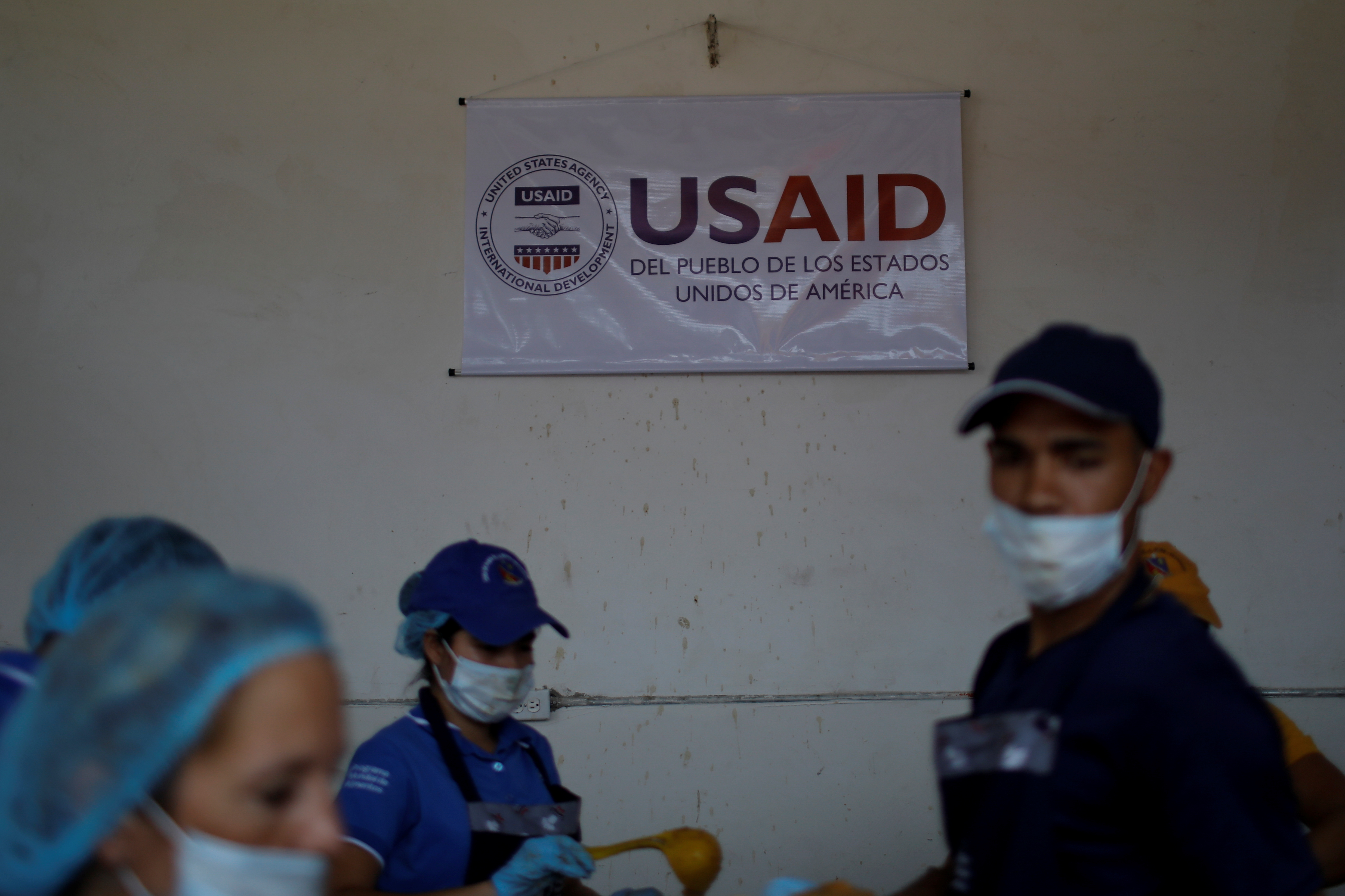 A USAID sign hangs above a community soup kitchen