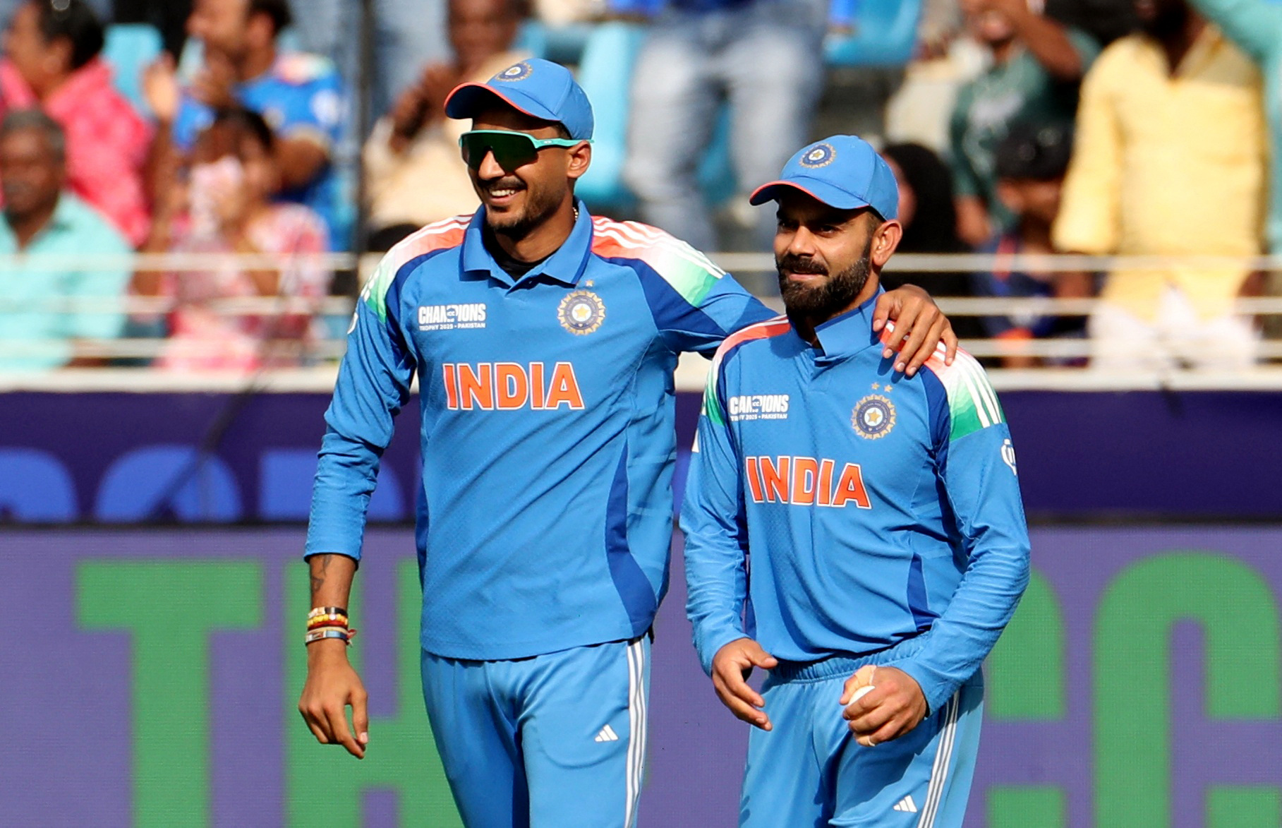 Cricket - ICC Men's Champions Trophy - Group A - Bangladesh v India - Dubai International Stadium, Dubai, United Arab Emirates - February 20, 2025 India's Virat Kohli celebrates with Axar Patel after taking the catch to dismiss Bangladesh's Jaker Ali, off the bowling of Mohammed Shami REUTERS/Satish Kumar