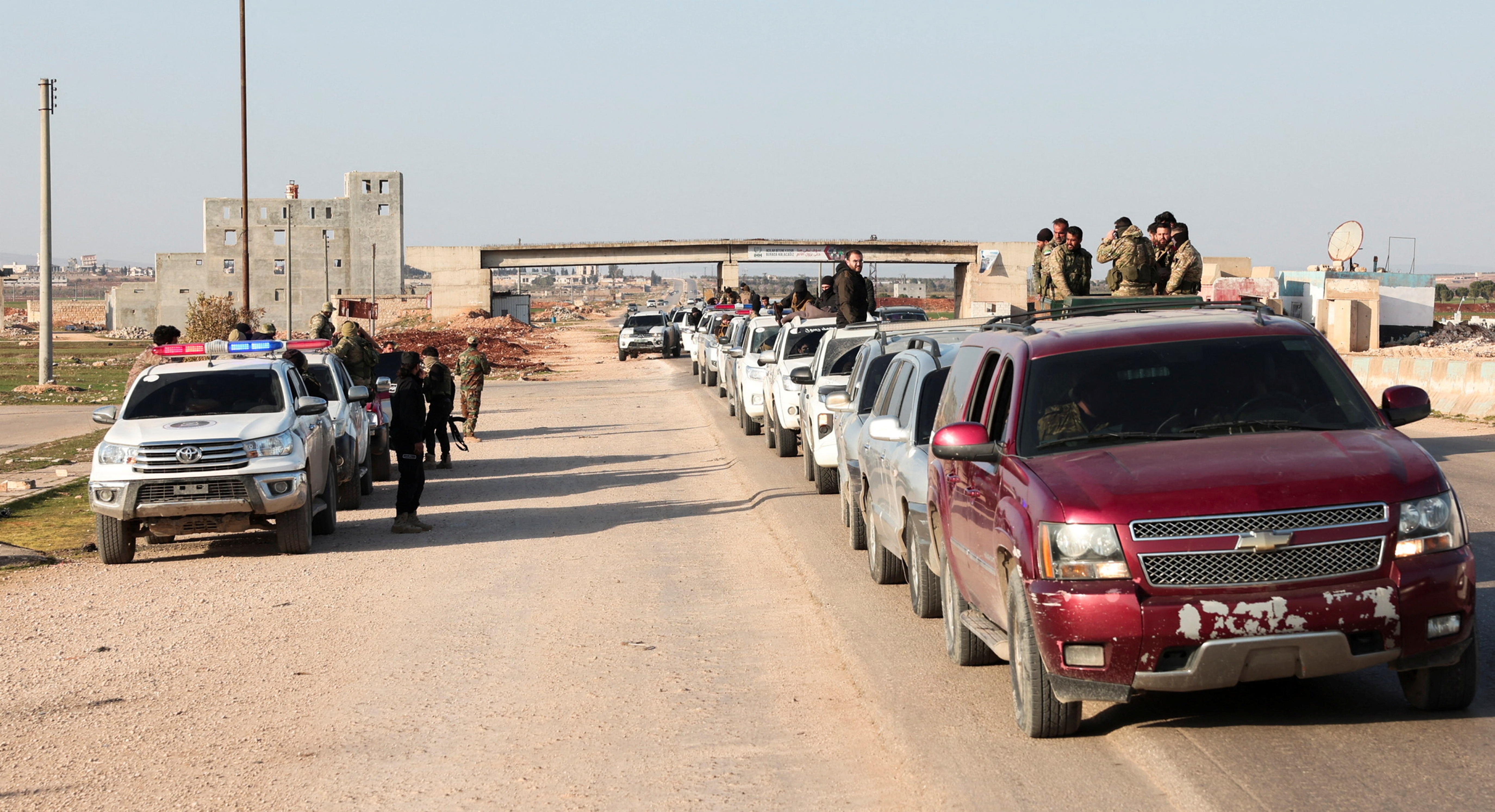 A military convoy heads towards Latakia to join the fight against the fighters linked to Syria's ousted leader Bashar al-Assad, in Aleppo