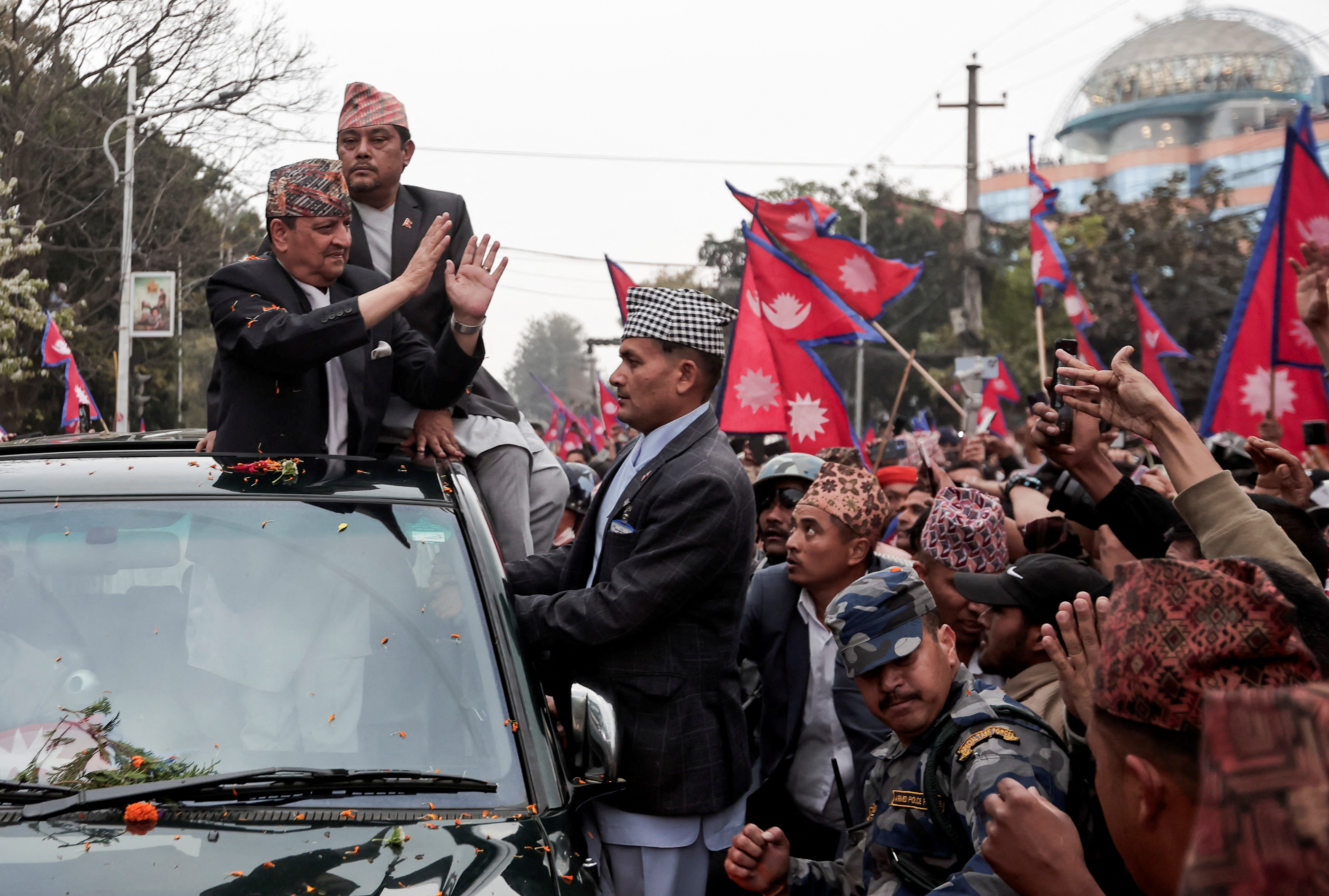 Former King of Nepal Gyanendra Bir Bikram Shah Dev is welcomed by pro-monarchy supporters.