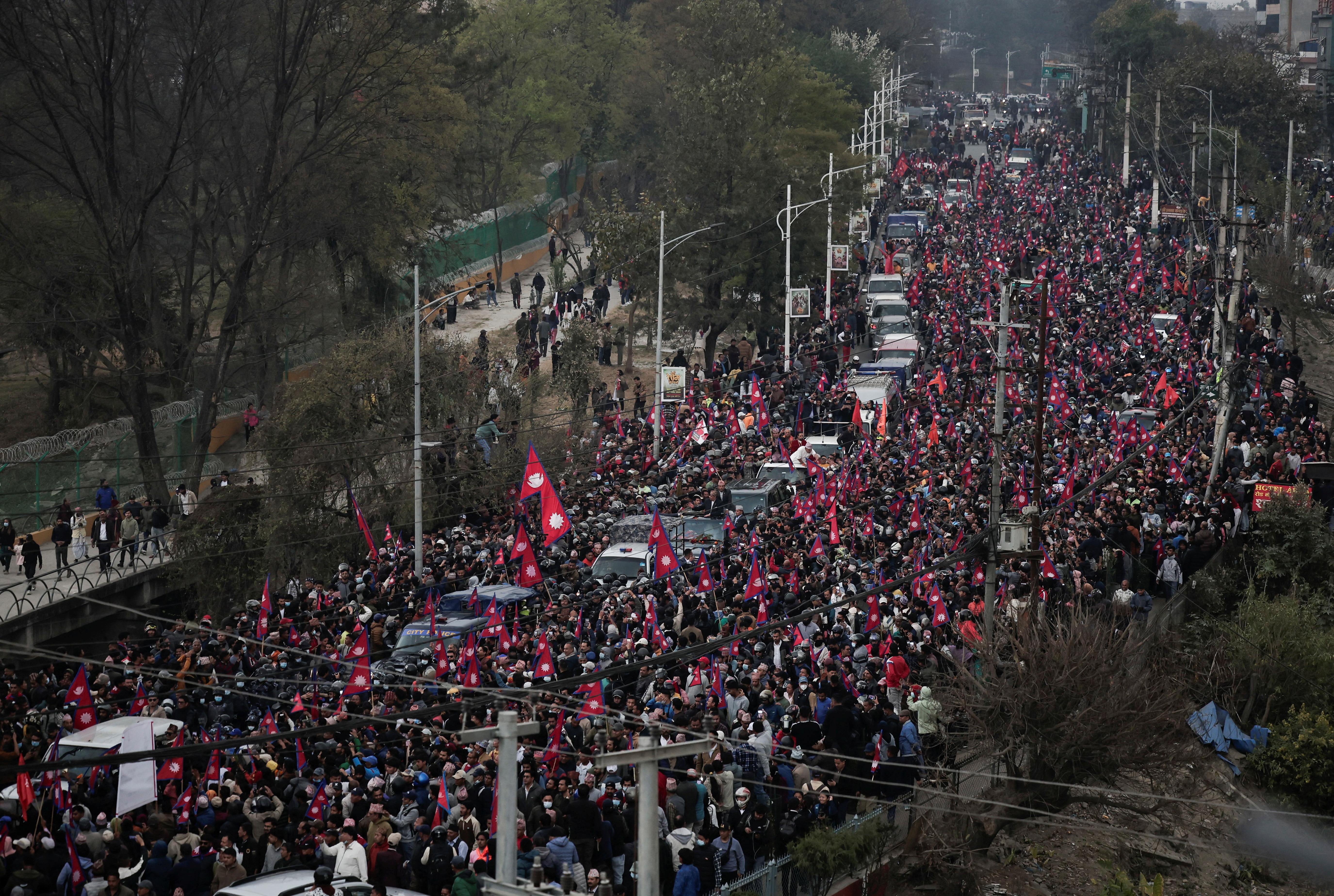 Pro-monarchy supporters demanding the restoration of monarchy, which was abolished in 2008, gather around the vehicle carrying former King of Nepal Gyanendra Bir Bikram Shah Dev, upon his arrival outside the Tribhuvan International Airport in Kathmandu, Nepal March 9, 2025. REUTERS/Navesh Chitrakar
