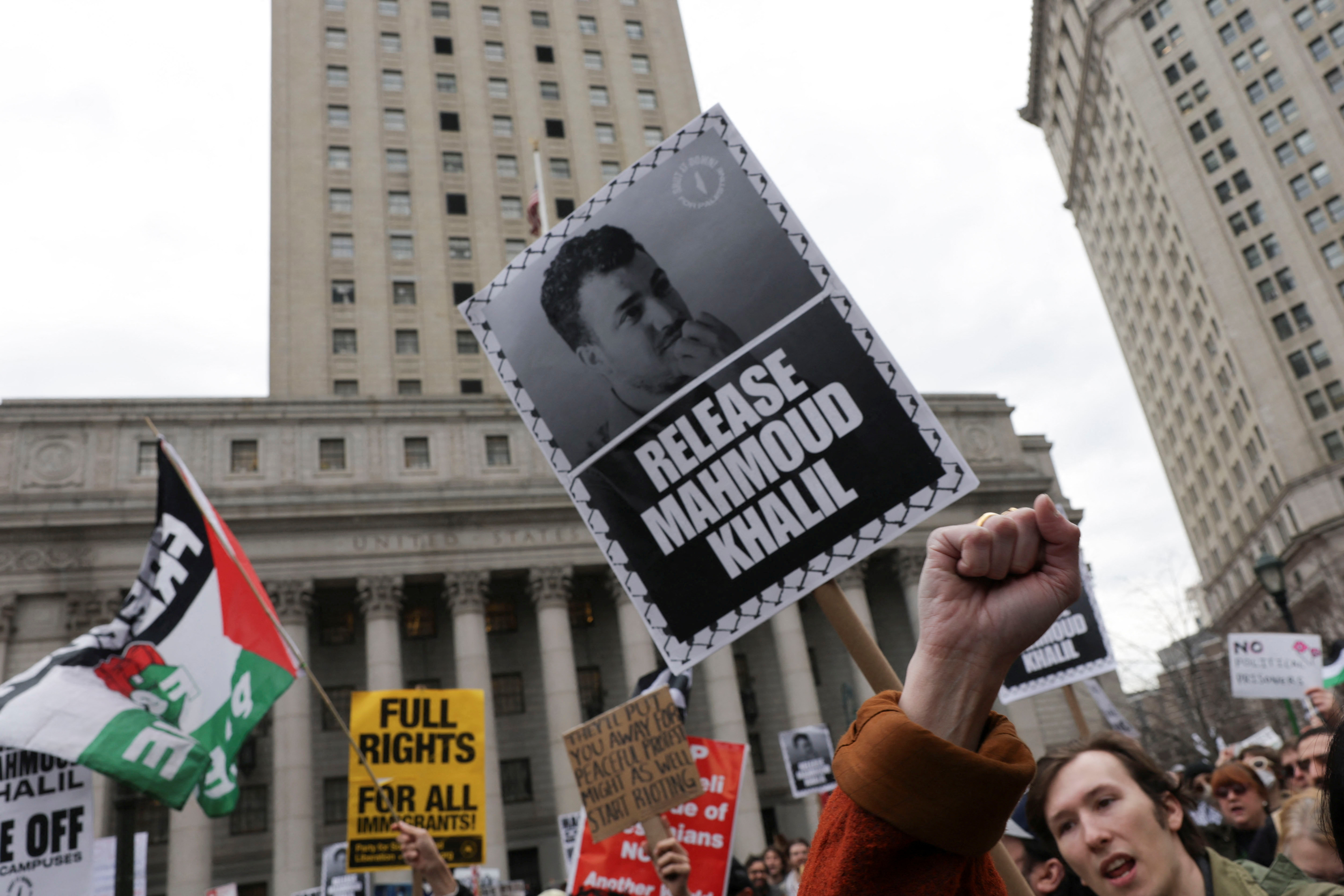 Demonstrators hold placards as they protest on the day of a hearing on the detention of Palestinian activist and Columbia University graduate student Mahmoud Khalil, in New York City, U.S., March 12, 2025. REUTERS/Jeenah Moon