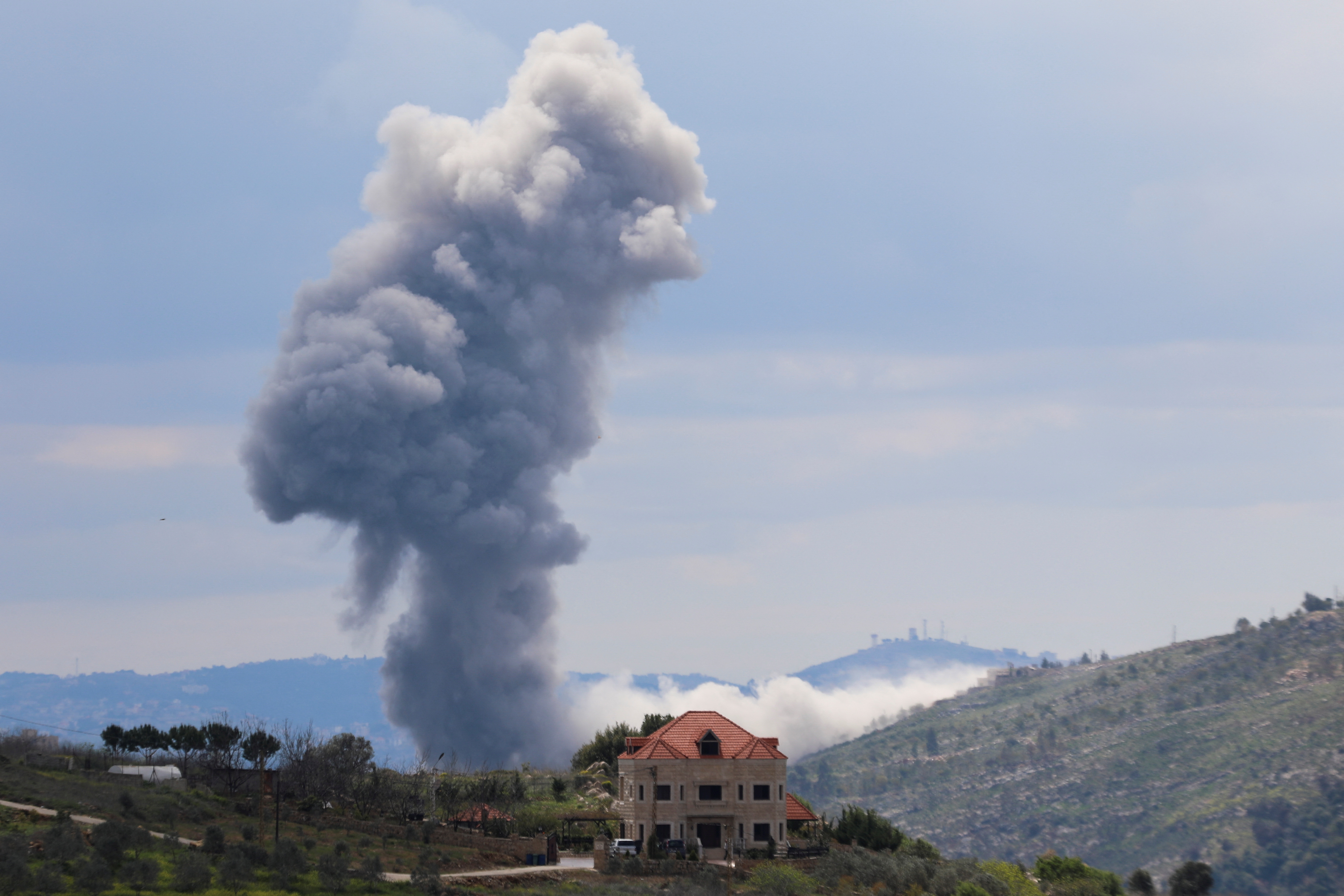 Smoke rises from Taibeh, following Israeli strikes in response to cross-border rocket fire, as seen from Marjayoun in southern Lebanon, March 22, 2025. REUTERS/Karamallah Daher