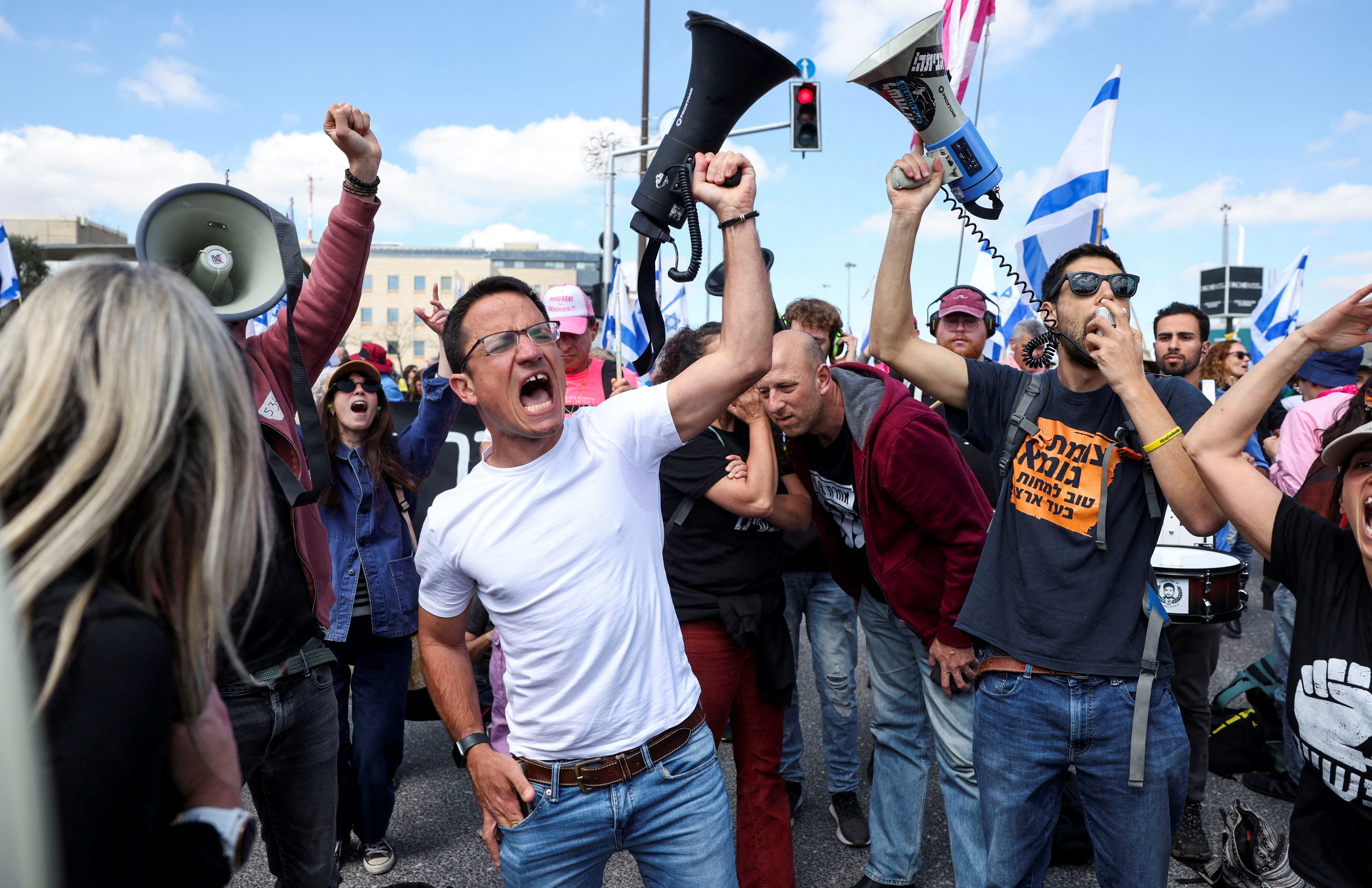 People take part in a protest against moves by the Israeli Government to fire the Attorney General Gali Baharav Miara and the dismissal of top security agency chief, Ronen Bar, as cabinet meeting is taking place, in Jerusalem March 23, 2025. REUTERS/Ronen Zvulun TPX IMAGES OF THE DAY