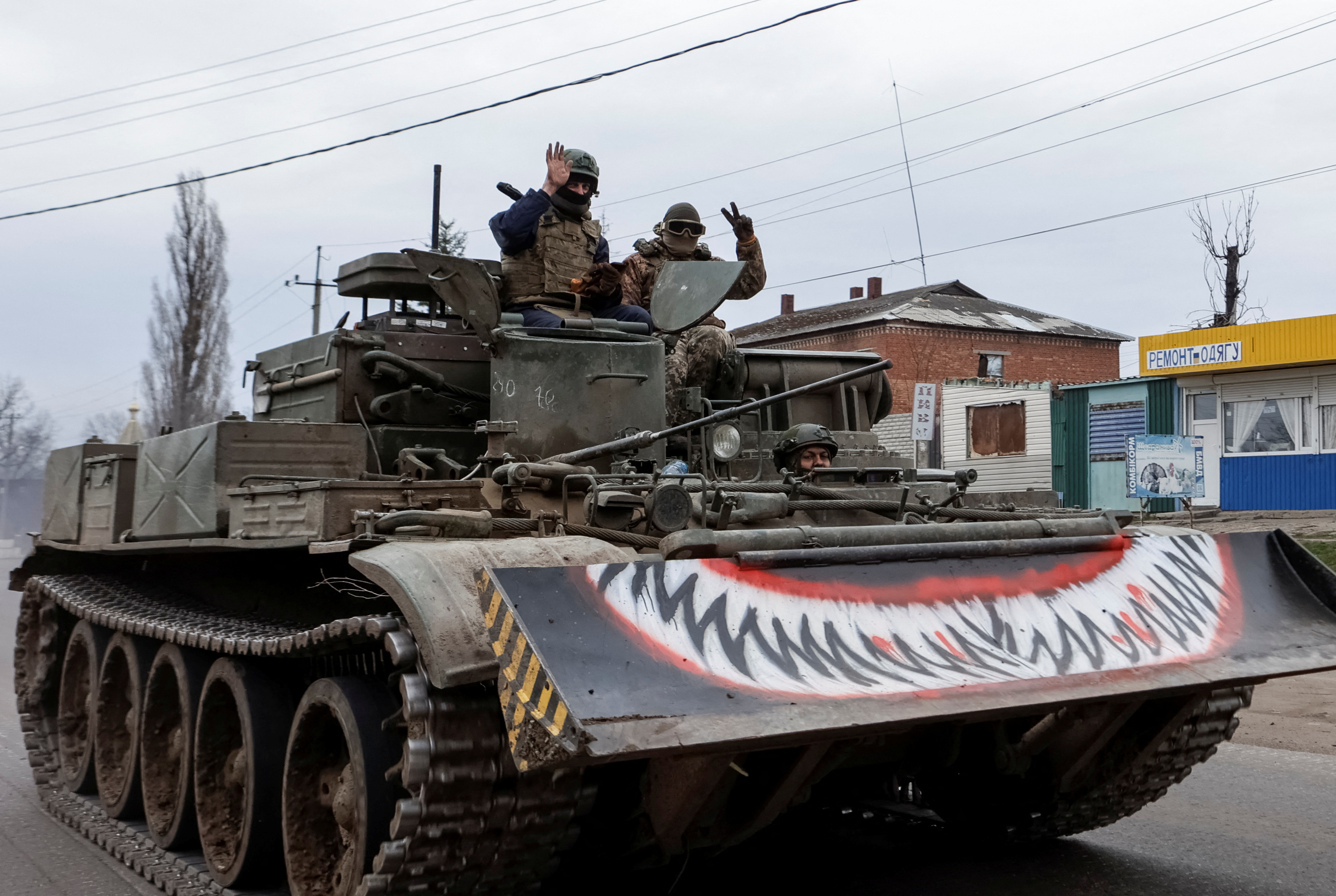 Ukrainian servicemen ride a military vehicle, amid Russia's attack on Ukraine, in the Kharkiv Region, Ukraine March 25, 2025. REUTERS/Sofiia Gatilova