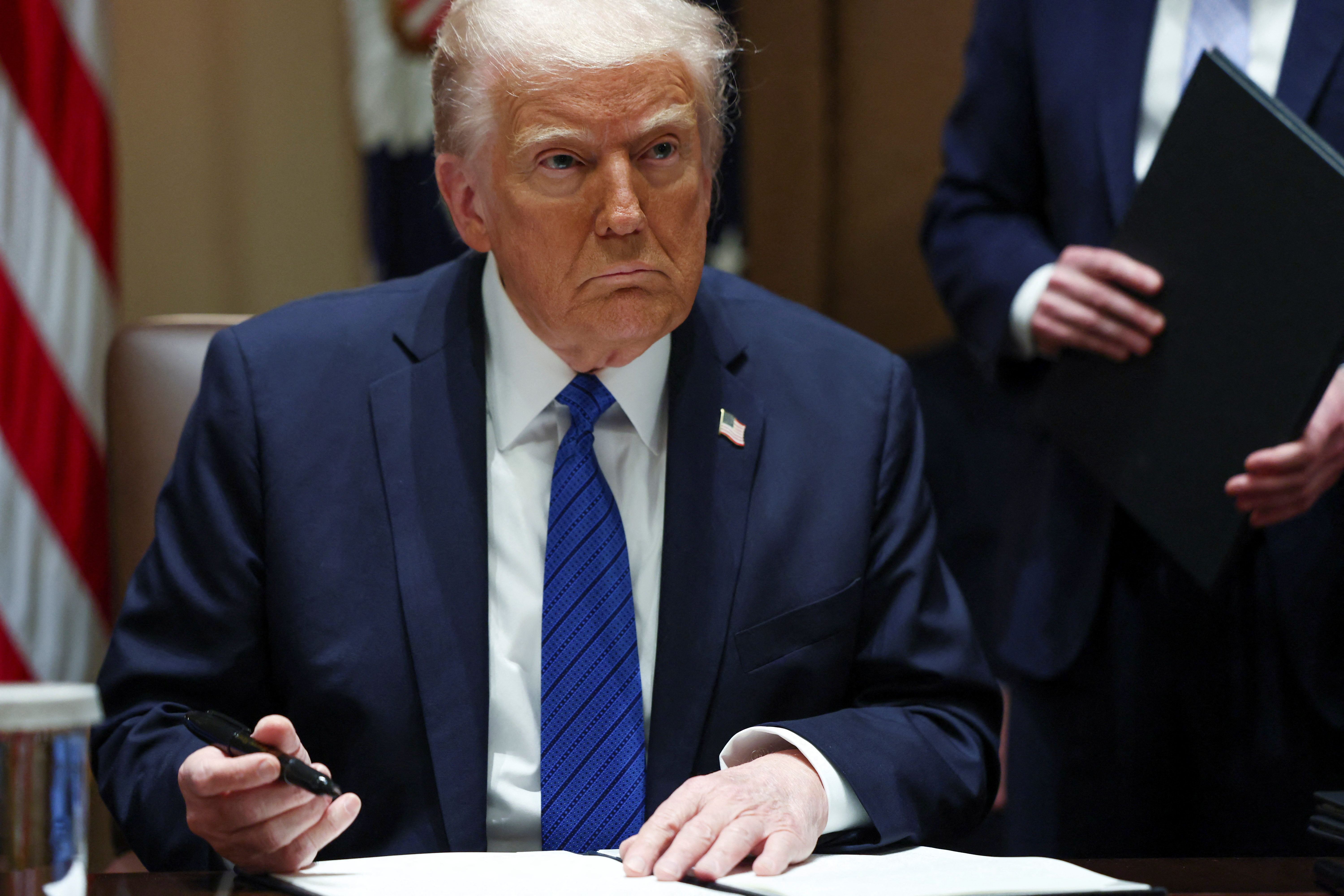 President Donald Trump looks on on the day of a meeting with U.S. ambassadors