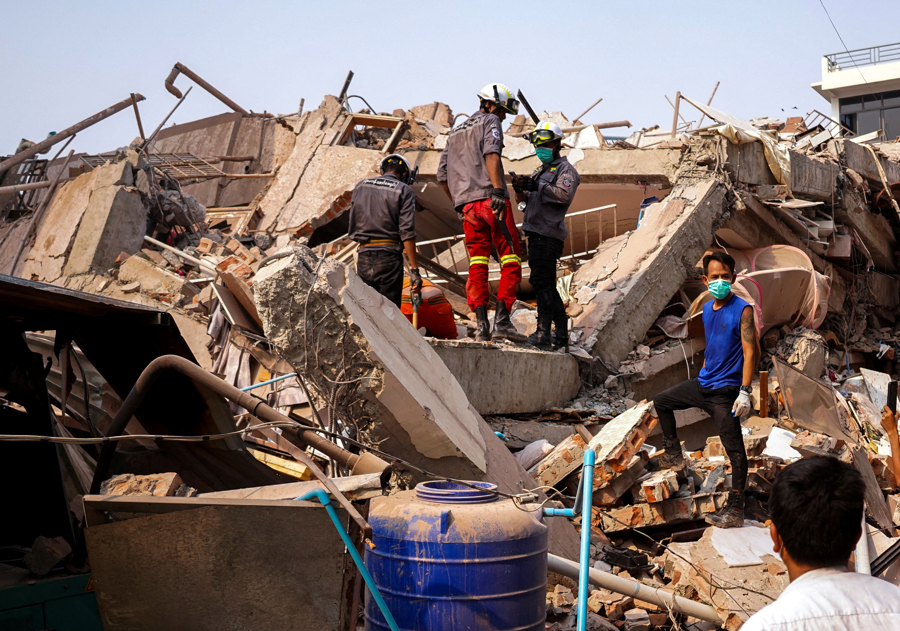 Rescuers work at the site of a building that collapsed.