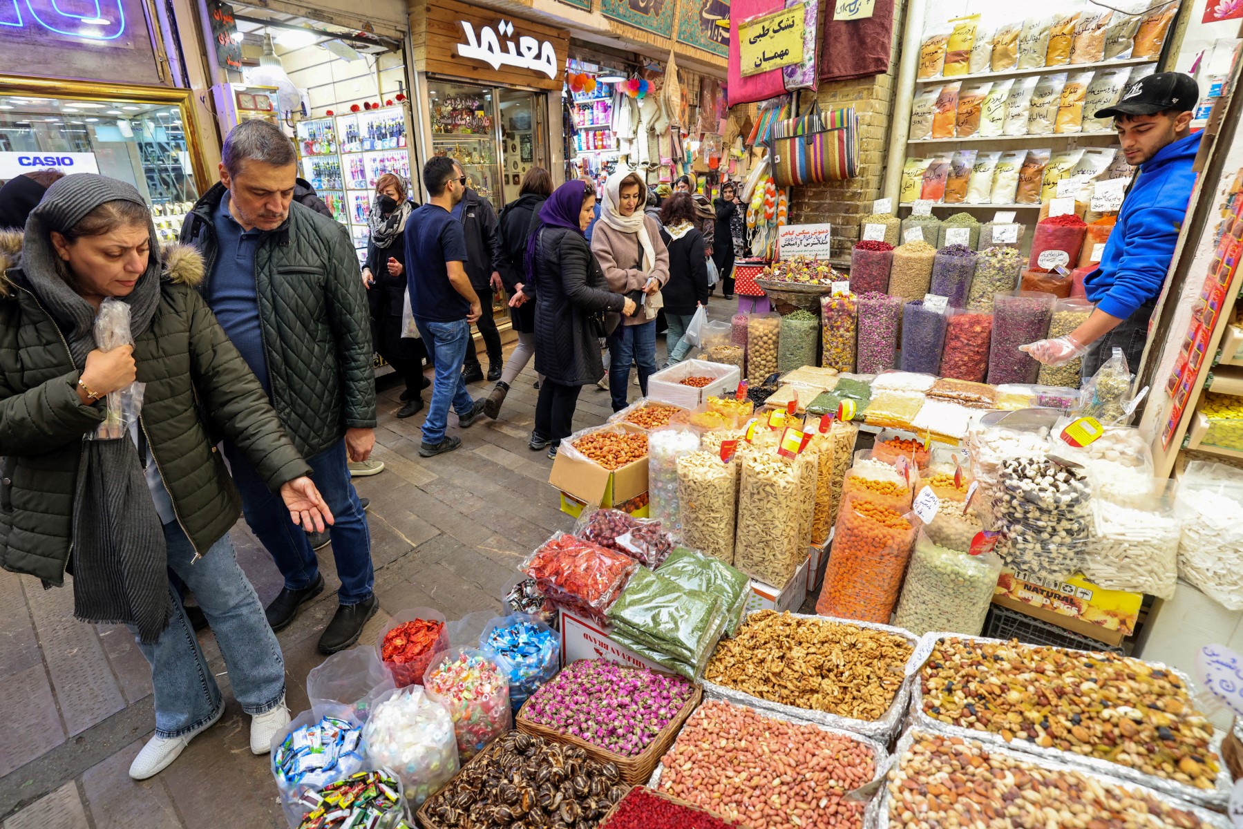 People shop at a market in Tehran on March 12, 2024, as they prepare for Nowruz, the Persian New Year.