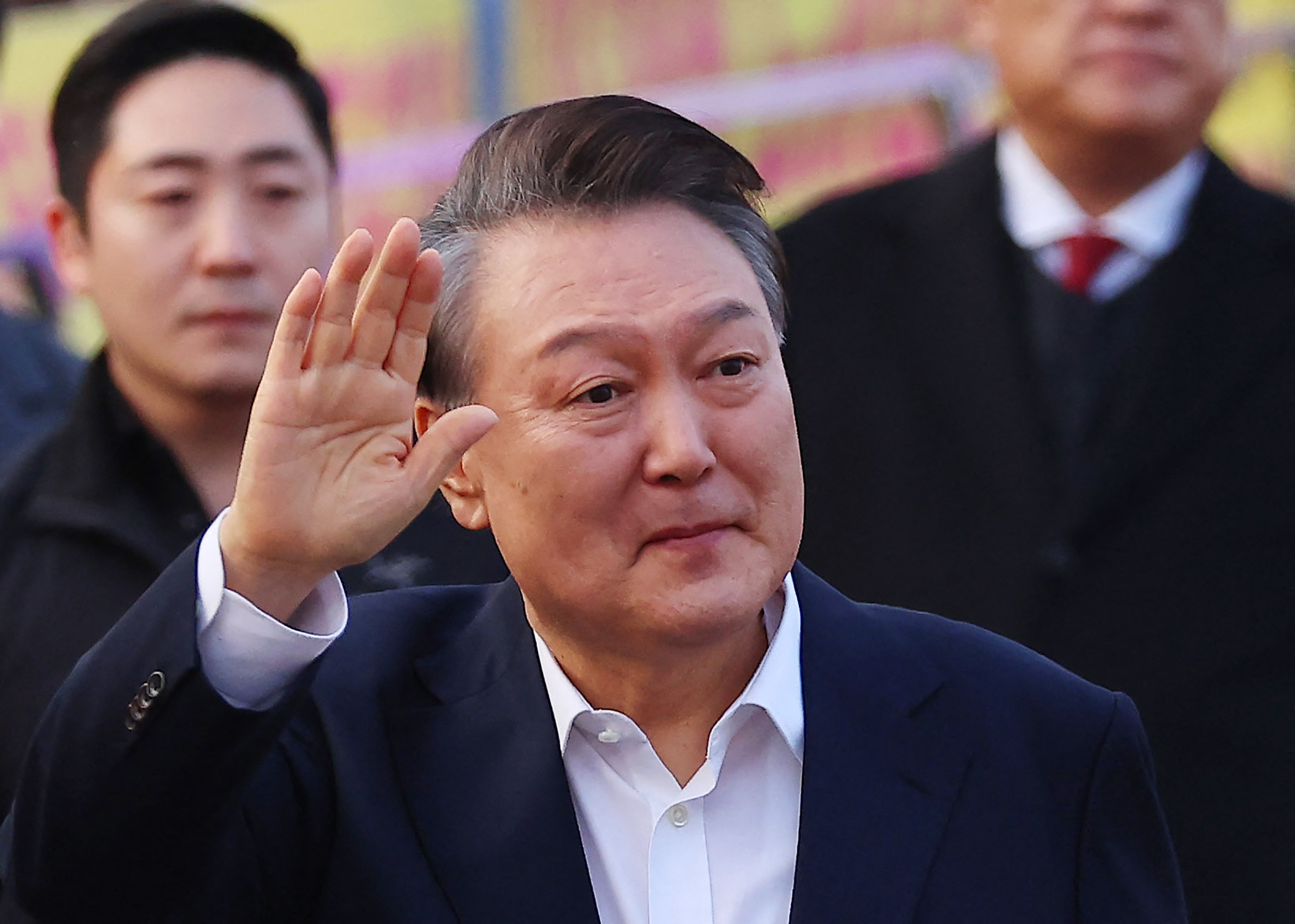 Impeached South Korean President Yoon Suk Yeol waves to his supporters outside the Seoul Detention Center in Uiwang on March 8, 2025.