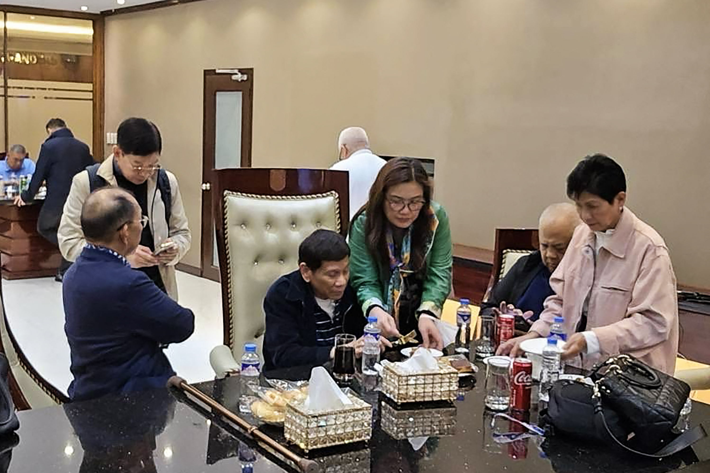 TOPSHOT - This handout photo taken and released by the Partido Demokratiko Pilipino–Lakas ng Bayan (PDP Laban) on March 11, 2025, shows former Philippines' president Rodrigo Duterte (C) inside the Villamor Air Base in Pasay, Metro Manila, after arriving from Hong Kong. Former Philippines president Rodrigo Duterte, arrested on March 11 on an International Criminal Court warrant for alleged crimes against humanity during his "war on drugs", once said he would be happy to kill three million addicts. (Photo by Handout / PARTIDO DEMOKRATIKO PILIPINO–LAKAS NG BAYAN (PDP LABAN) / AFP) / NO USE AFTER APRIL 10, 2025 05:37:52 GMT - RESTRICTED TO EDITORIAL USE - MANDATORY CREDIT "AFP PHOTO / PARTIDO DEMOKRATIKO PILIPINO–LAKAS NG BAYAN (PDP LABAN)" - NO MARKETING NO ADVERTISING CAMPAIGNS - DISTRIBUTED AS A SERVICE TO CLIENTS - NO ARCHIVES