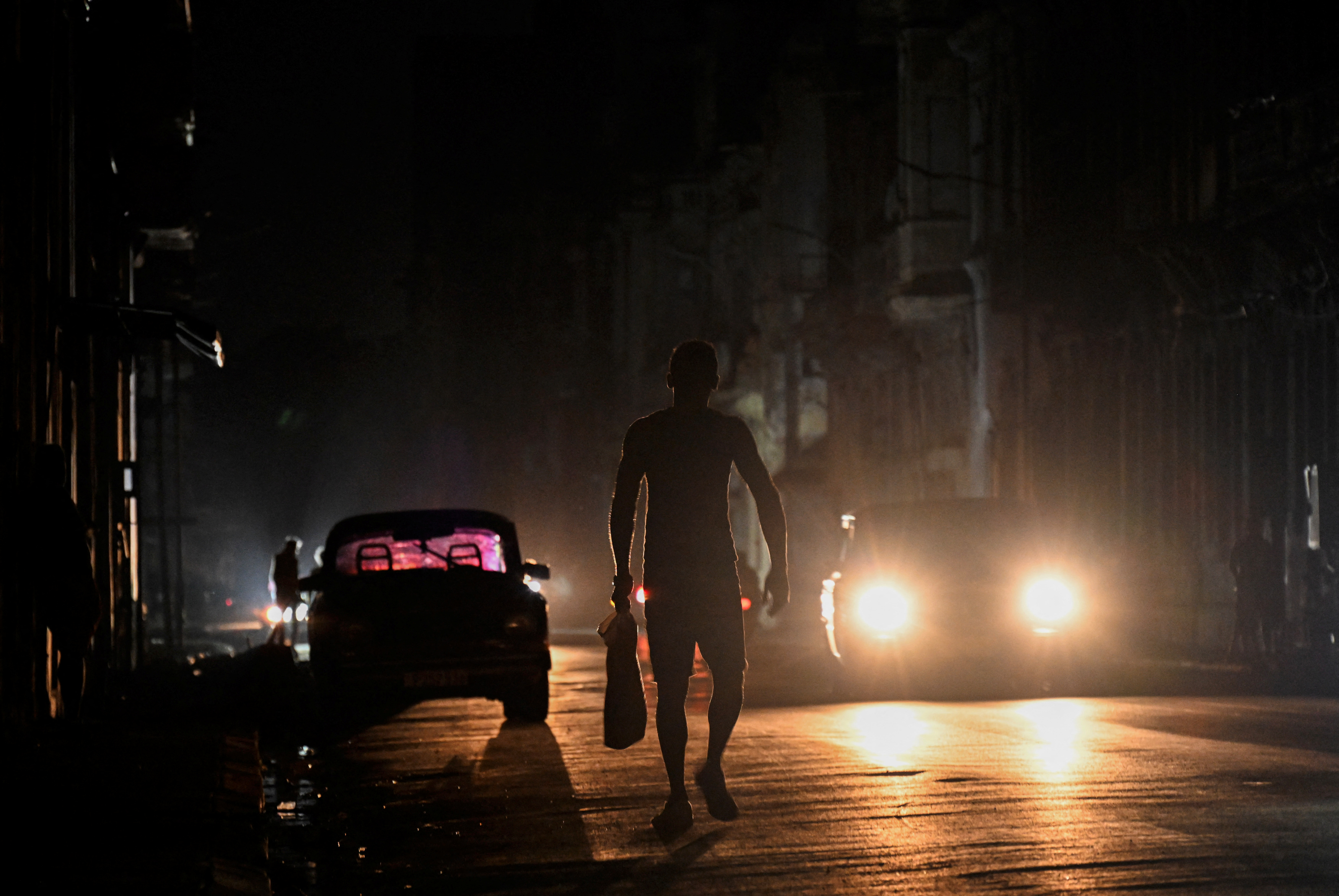 A man walks on a street during a blackout in Havana in March 2025