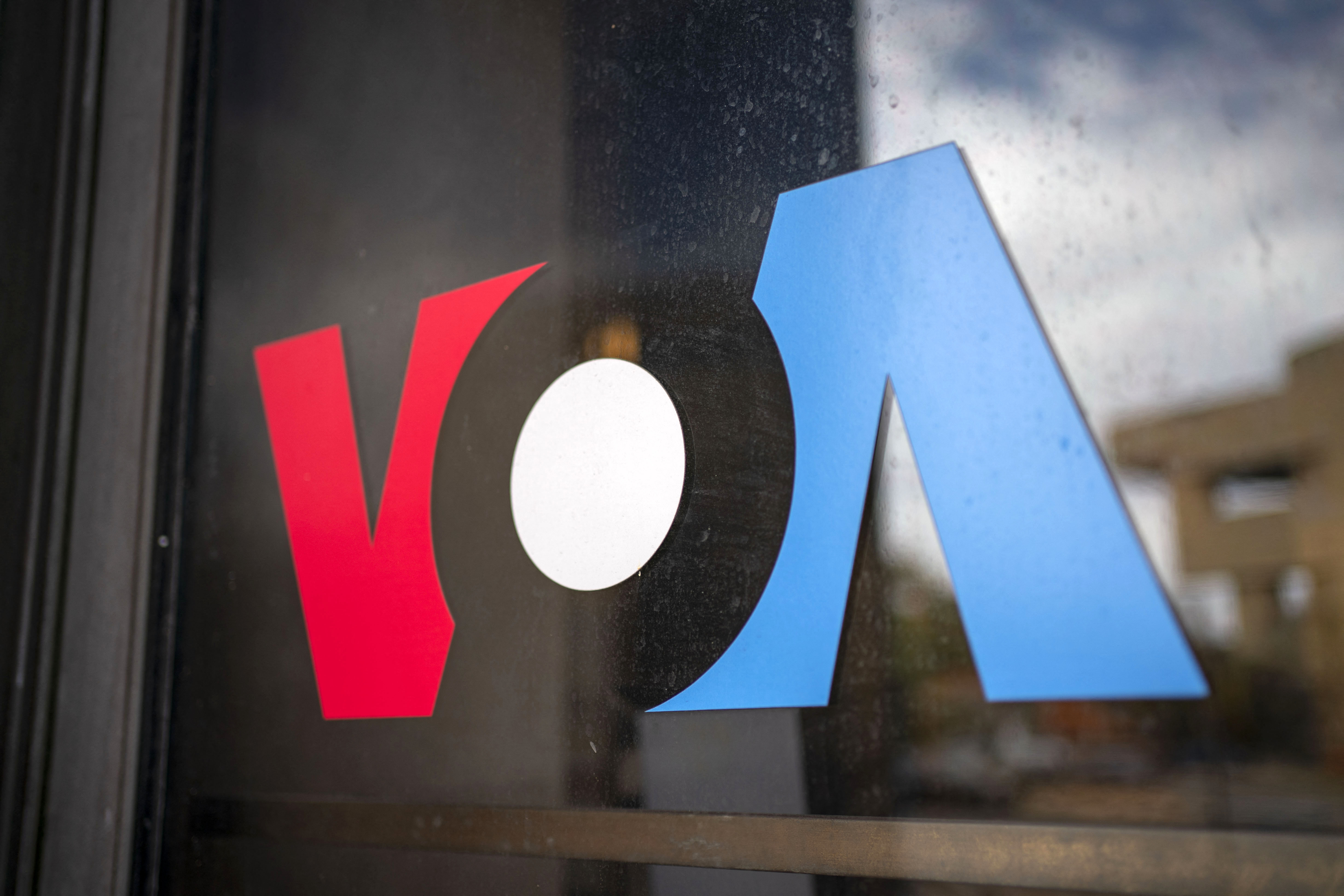 Signage for US broadcaster Voice of America is seen in Washington, DC, on March 16, 2025. US President Donald Trump's administration on March 15 put journalists at Voice of America and other US-funded broadcasters on leave, abruptly freezing decades-old outlets long seen as critical to countering Russian and Chinese information offensives [Bonnie Cash/AFP]