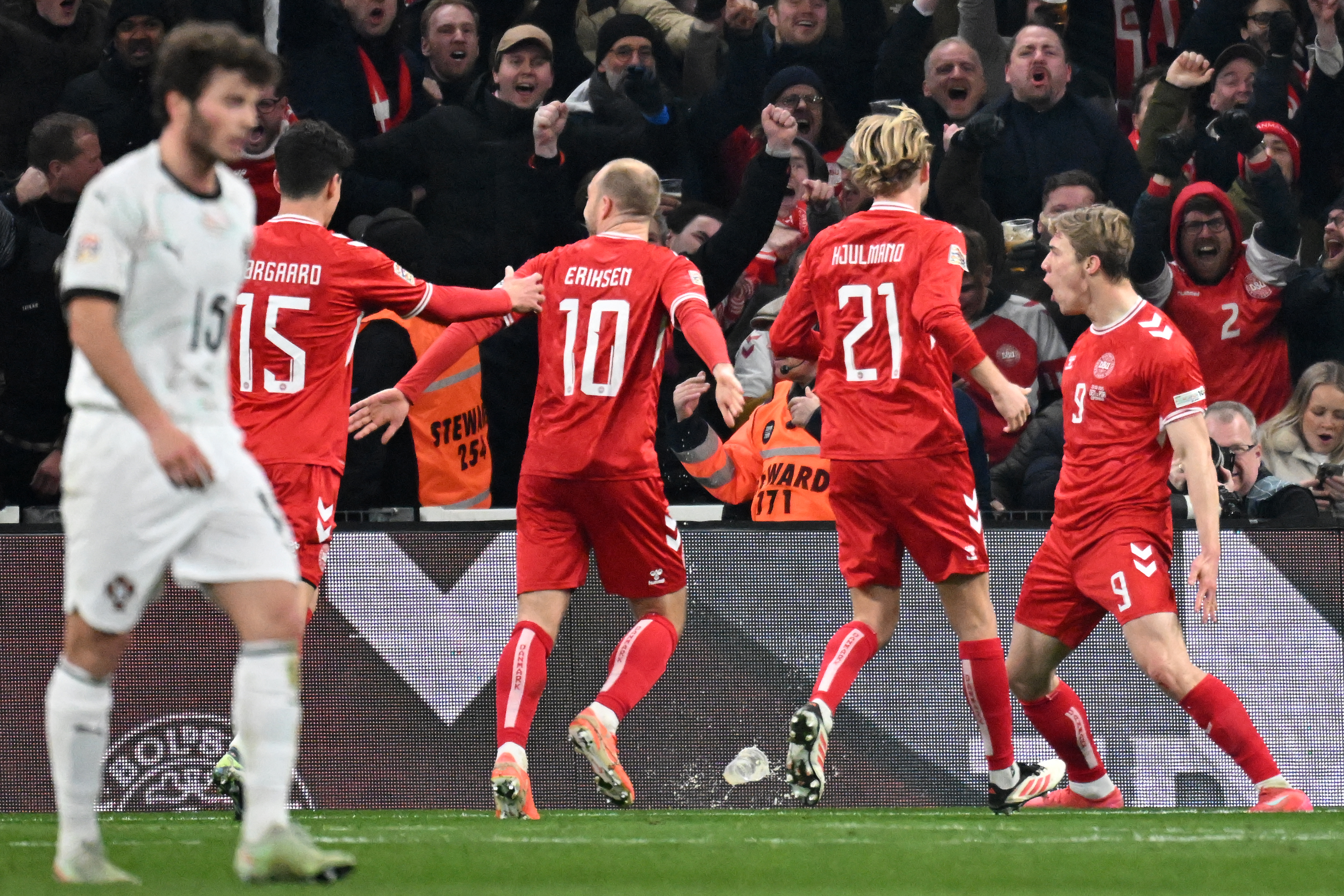 Denmark's players celebrate after Denmark's forward #09 Rasmus Hoejlund (R) scored his team's first goal during the UEFA Nations League quarter-final, first-leg football match Denmark v Portugal at the Parken Stadium in Copenhagen on March 20, 2025. (Photo by Jonathan NACKSTRAND / AFP)