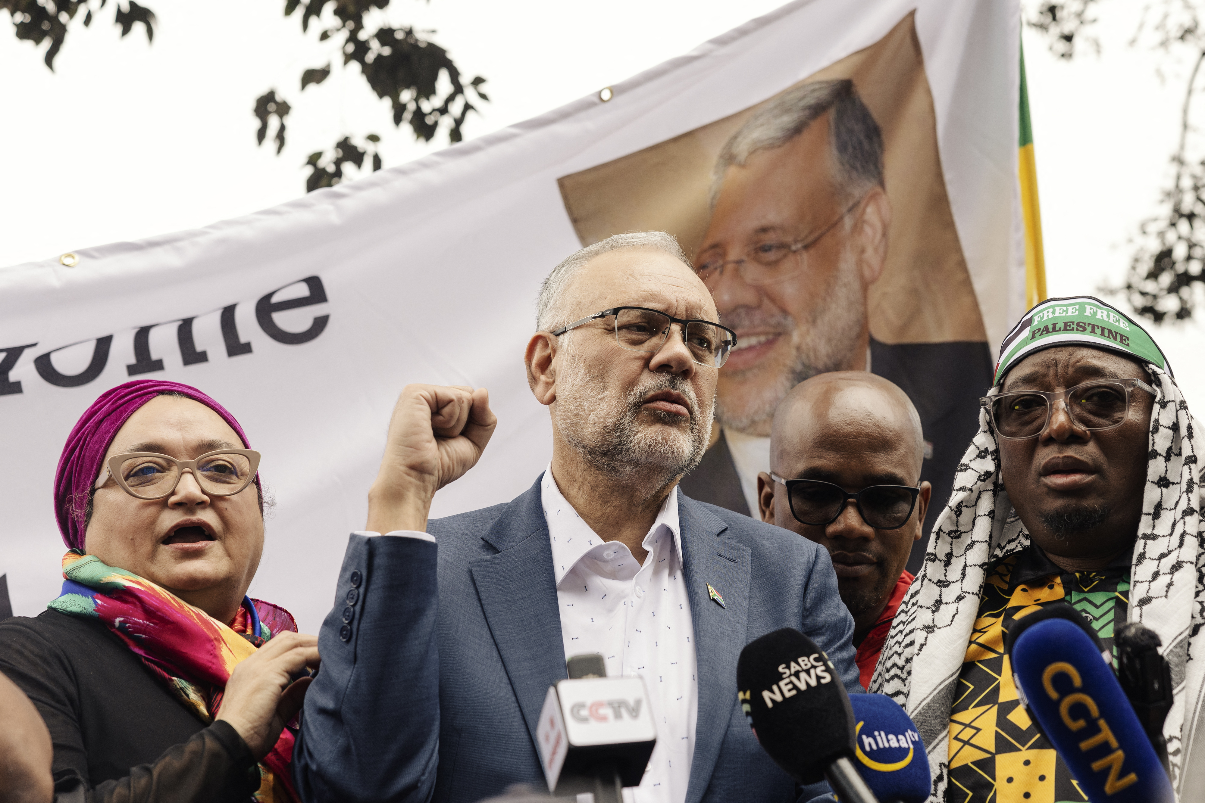 Former South African Ambassador to the United States Ebrahim Rasool (c), addresses supporters upon his arrival at the Cape Town International airport