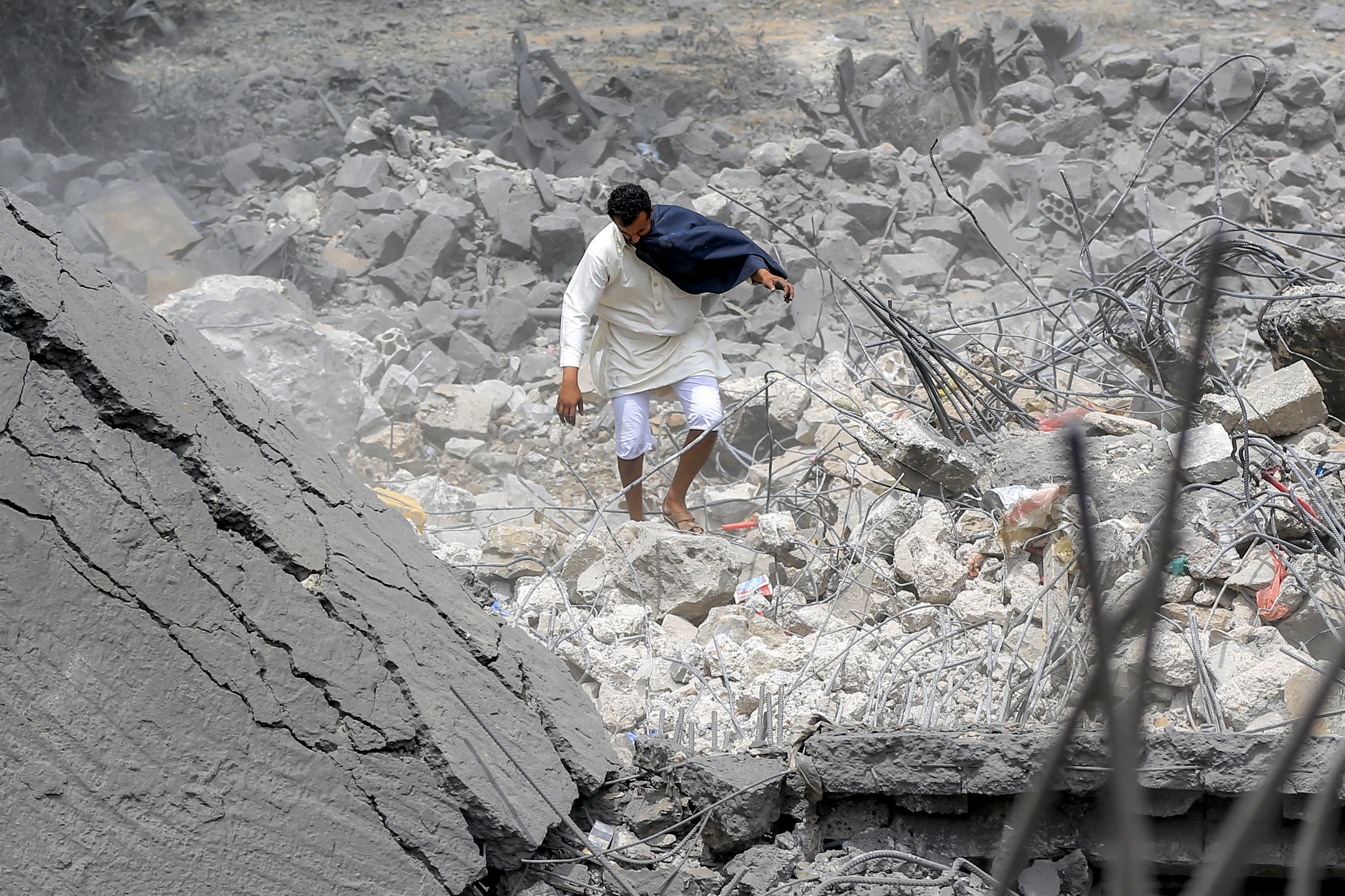 a man walks through a destroyed building