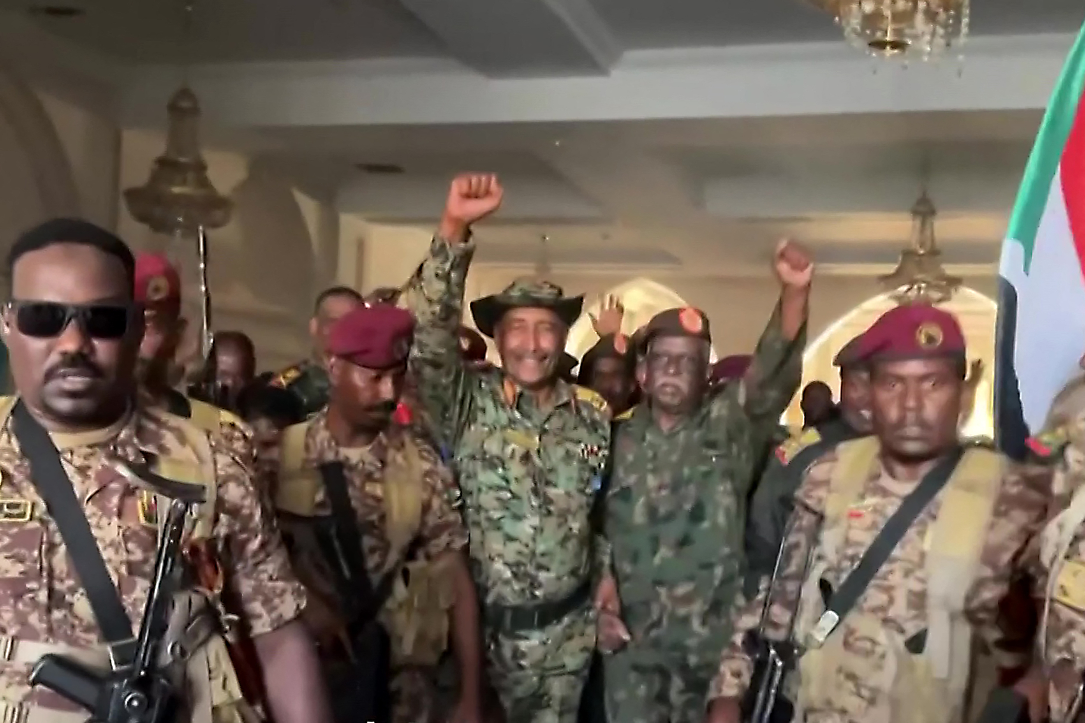 This image grab from a video received as a curtesy of Mohamed Nzar on March 26, 2025, shows Sudan's army chief Abdel Fattah al-Burhan surrounded by Sudanese soldiers celebrating after retaking the presidential palace in Khartoum from paramilitaries. Sudan's army chief Abdel Fattah al-Burhan arrived at Khartoum's recaptured presidential palace on March 26, declaring the capital "free" of the paramilitary Rapid Support Forces after nearly two years of war. (Photo by Mohamed NZAR / AFP) / NO USE AFTER APRIL 7, 2025 21:00:00 GMT - NO USE AFTER APRIL 7, 2025 21:00:00 GMT - RESTRICTED TO EDITORIAL USE - MANDATORY CREDIT AFP - SOURCE: UNKNOWN - NO MARKETING - NO ADVERTISING CAMPAIGNS - NO INTERNET - DISTRIBUTED AS A SERVICE TO CLIENTS - NO RESALE - AFP IS NOT RESPONSIBLE FOR ANY DIGITAL ALTERATIONS TO THE PICTURE'S EDITORIAL CONTENT /