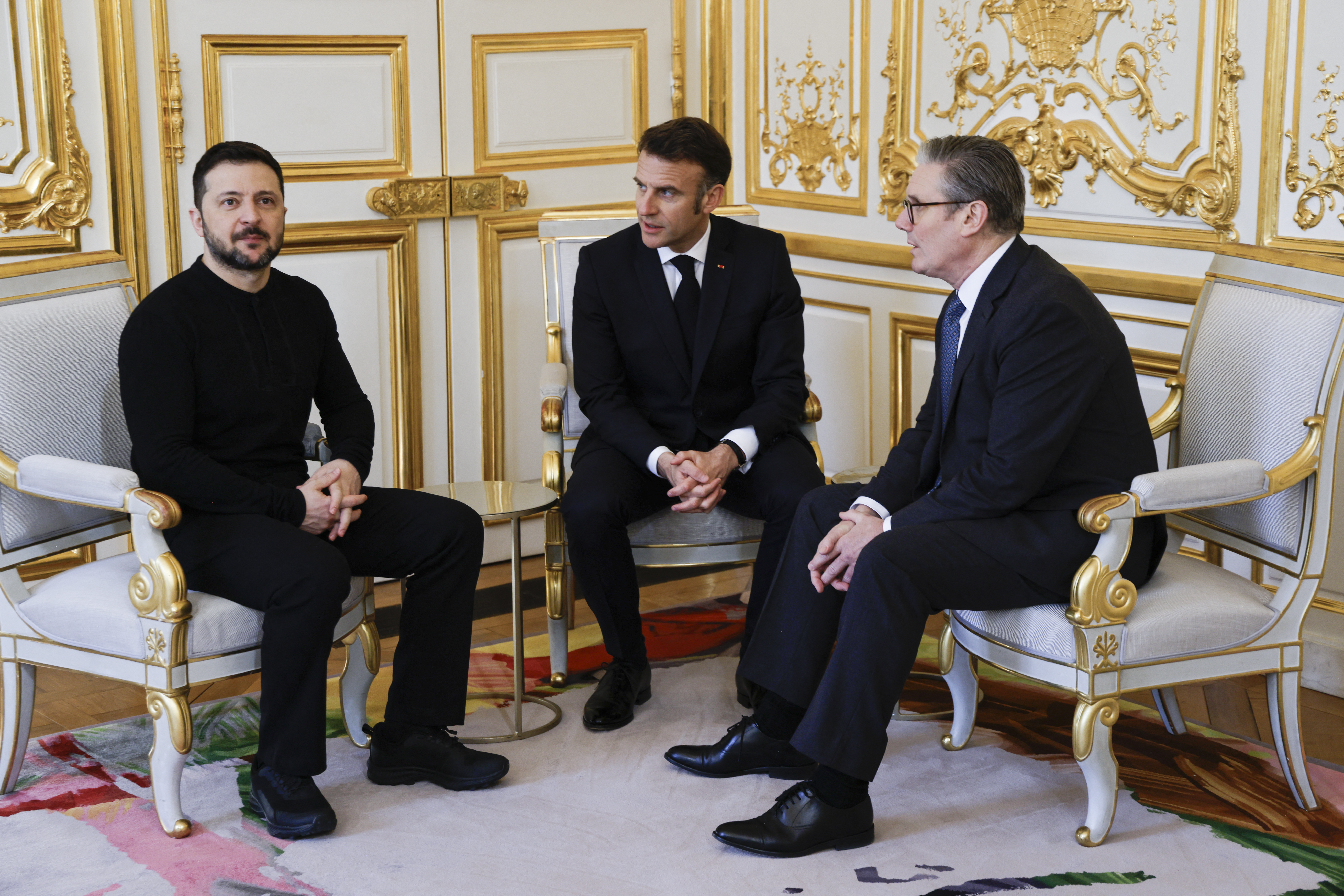 Ukraine's President Volodymyr Zelensky, France's President Emmanuel Macron and Britain's Prime Minister Keir Starmer speak during a trilateral meeting on the sidelines of a summit for "coalition of the willing" at the Elysee Palace, in Paris, on March 27, 2025