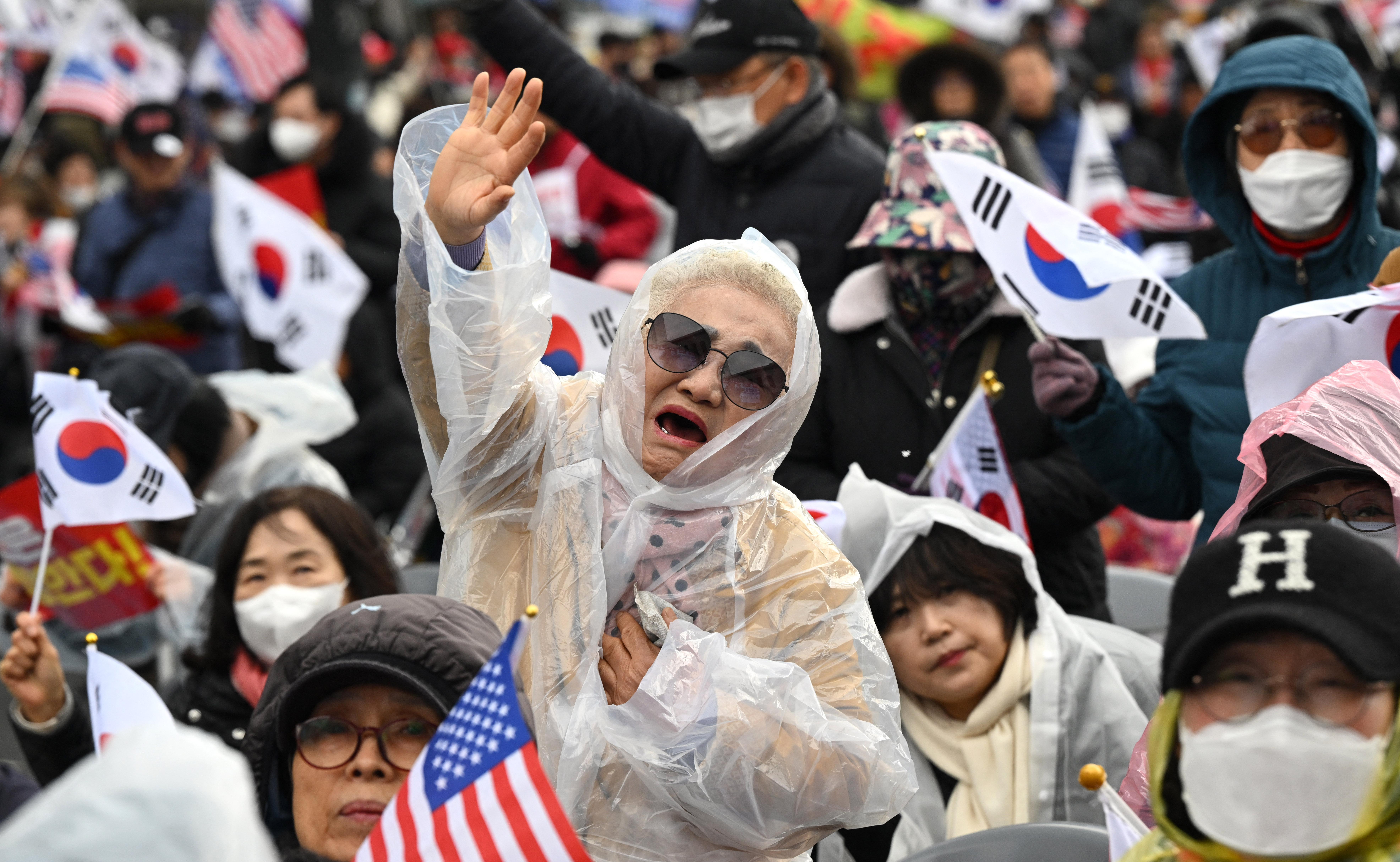 An elderly woman reacts during a street rally in support of impeached South Korean President Yoon Suk Yeol in Seoul on March 29, 2025, ahead of the impeachment verdict for the President.