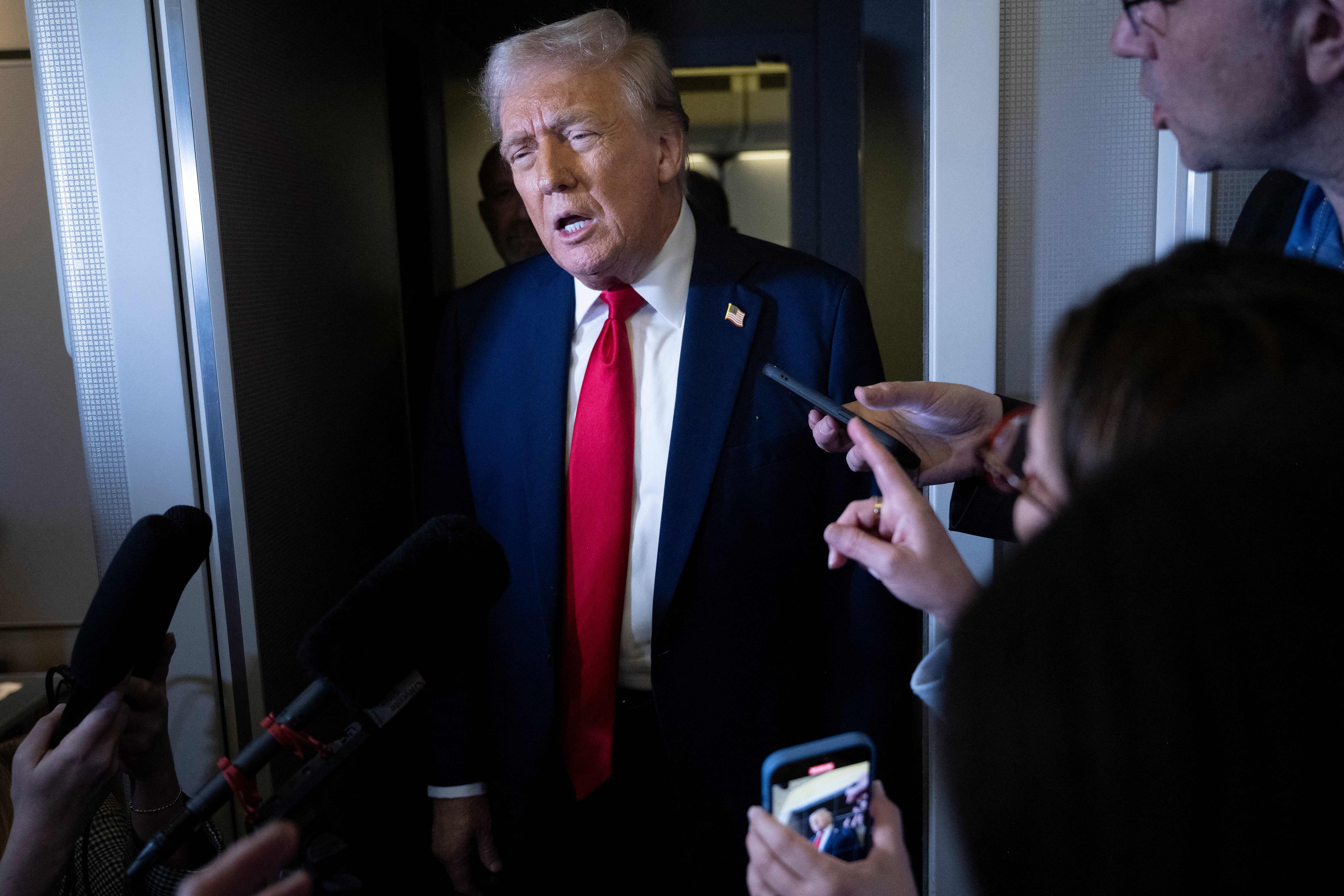 US President Donald Trump speaks to reporters on board Air Force One on his return to Washington, DC, US, on March 30, 2025