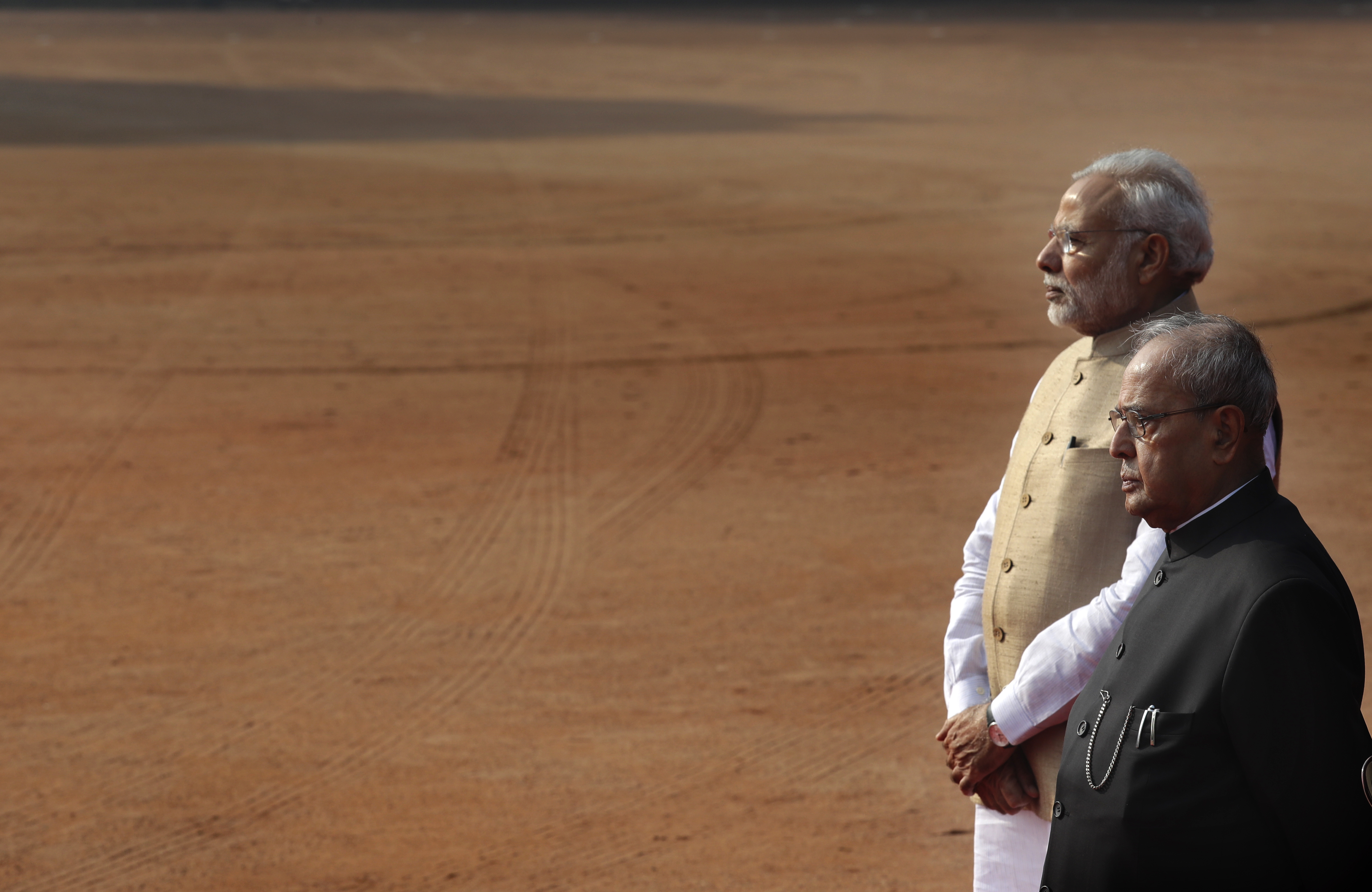 Indian President Pranab Mukherjee, right, with Indian Prime Minister Narendra Modi, wait for the arrival of visiting Indonesian President Joko Widodo at the Indian presidential palace in New Delhi, India, Monday, Dec. 12, 2016. (AP Photo/Manish Swarup)