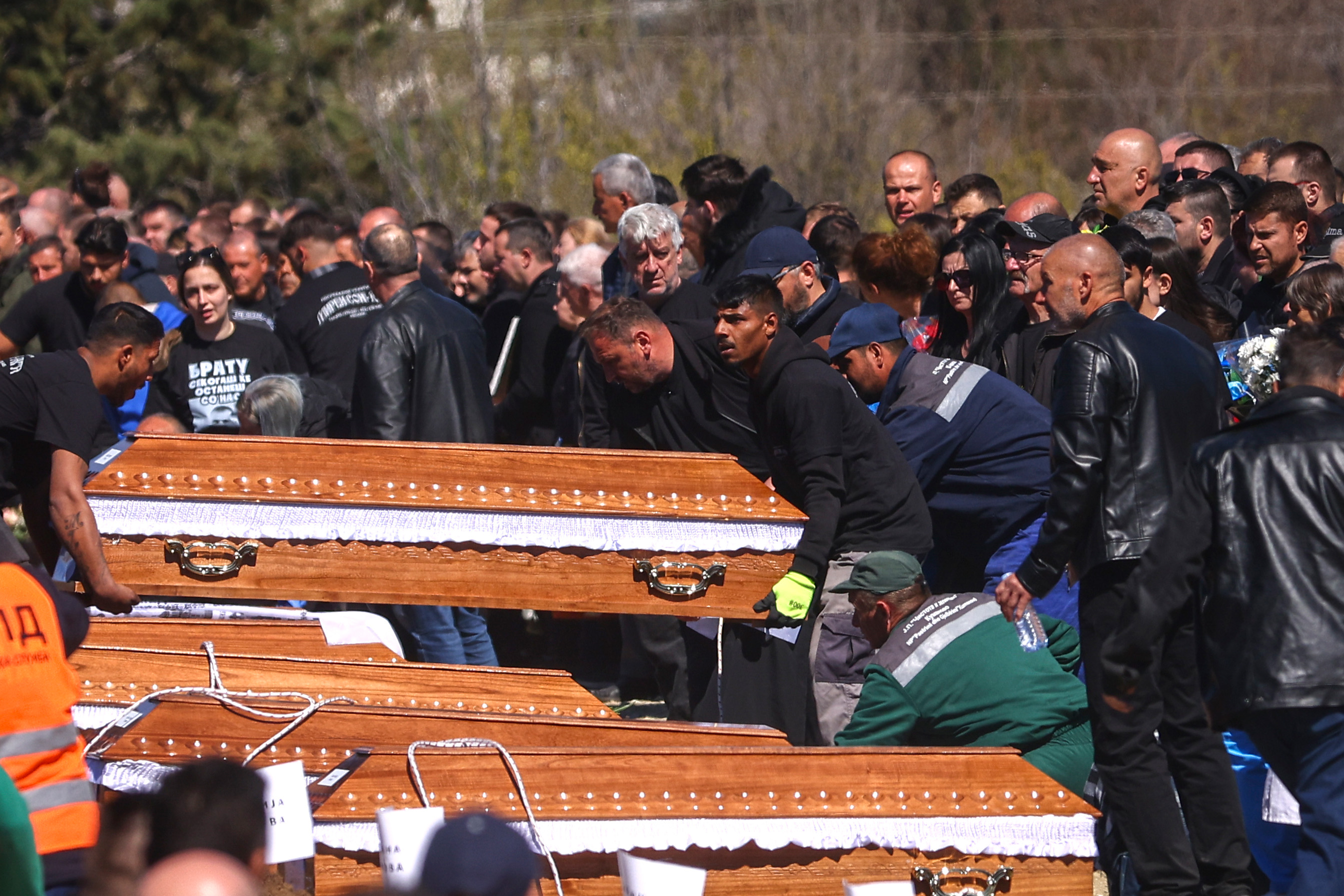 Coffins are placed next to the graves as people gather at a cemetery for the funeral ceremony of the victims of a massive nightclub fire in the town of Kocani, North Macedonia, Thursday, March 20, 2025. [Armin Durgut/AP Photo] (AP)