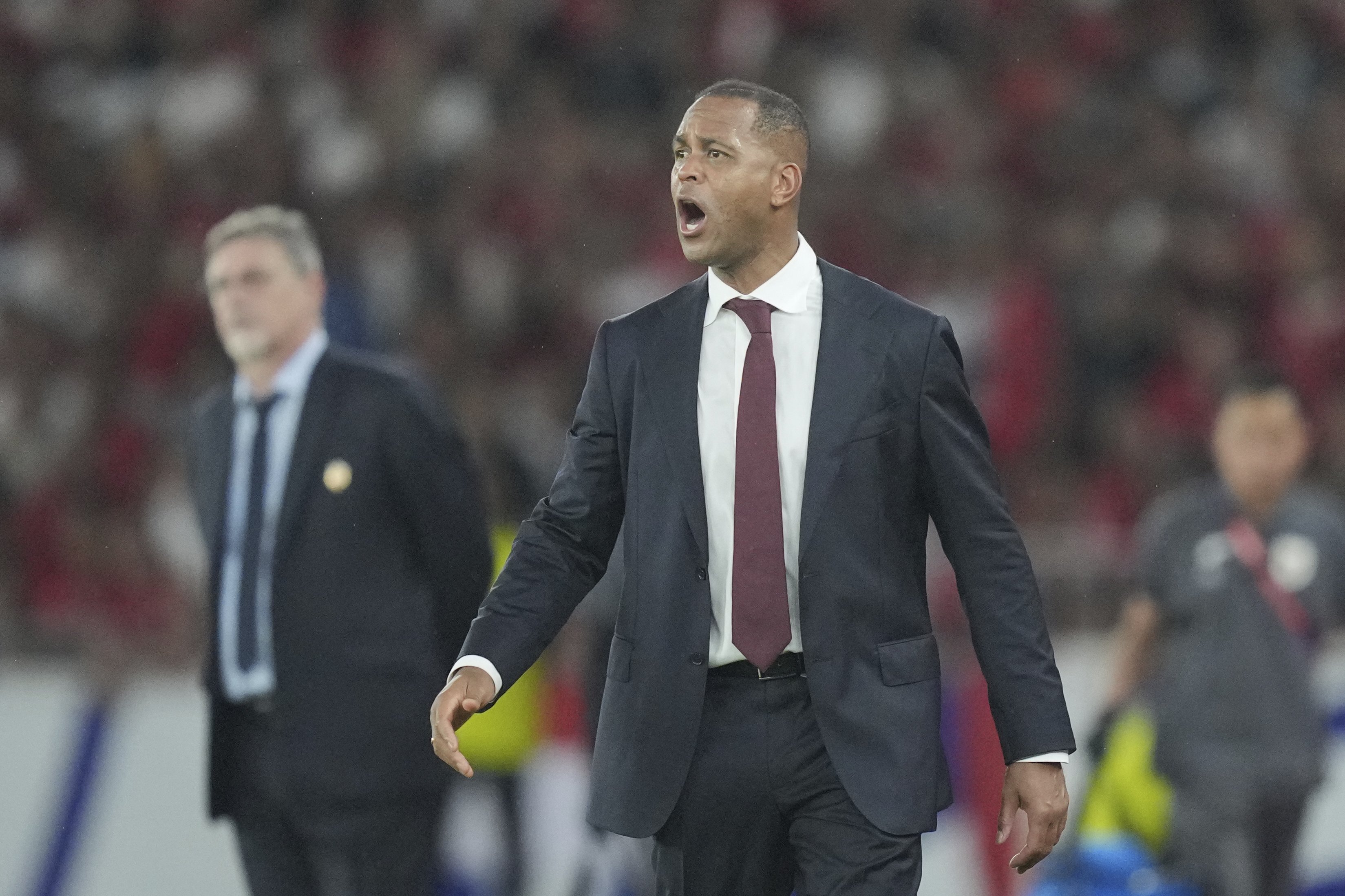 Indonesia's head coach Patrick Kluivert encourages his team during a World Cup 2026 group C Asia qualifying soccer match between Indonesia and Bahrain at Gelora Bung Karno Main Stadium in Jakarta, Indonesia, Tuesday, March 25, 2025. (AP Photo/Tatan Syuflana)