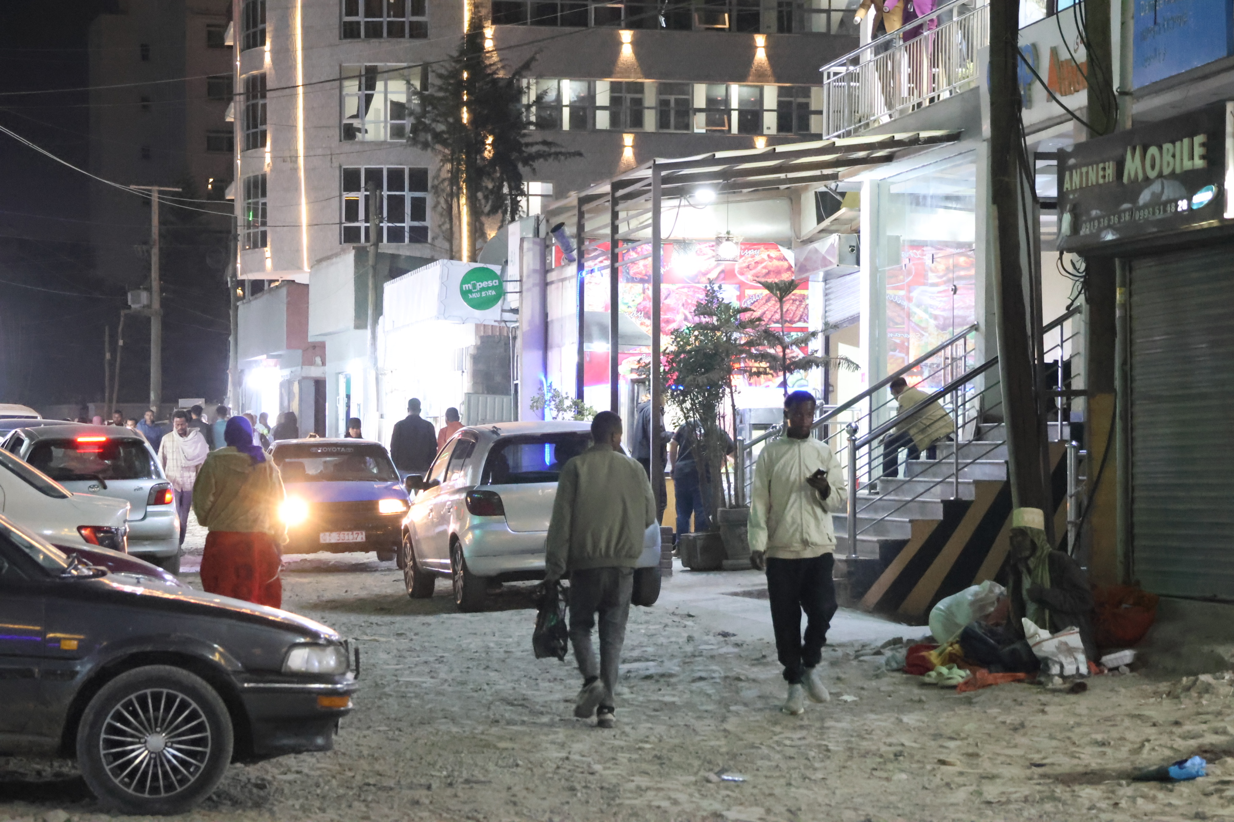 Men walking in a street at night
