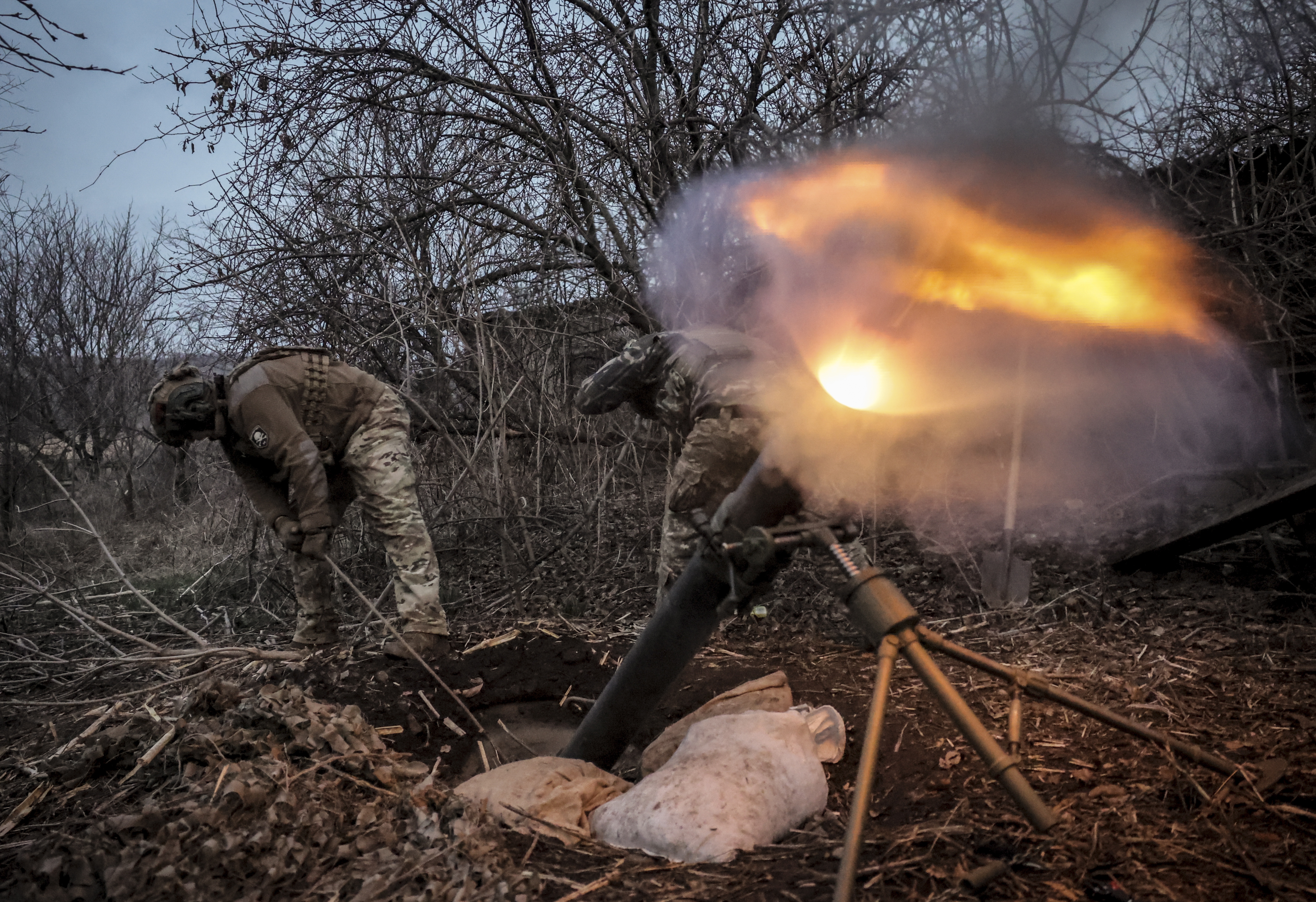 Ukrainian soldiers fire a 120mm mortar at Russian army positions near Chasiv Yar, Donetsk
