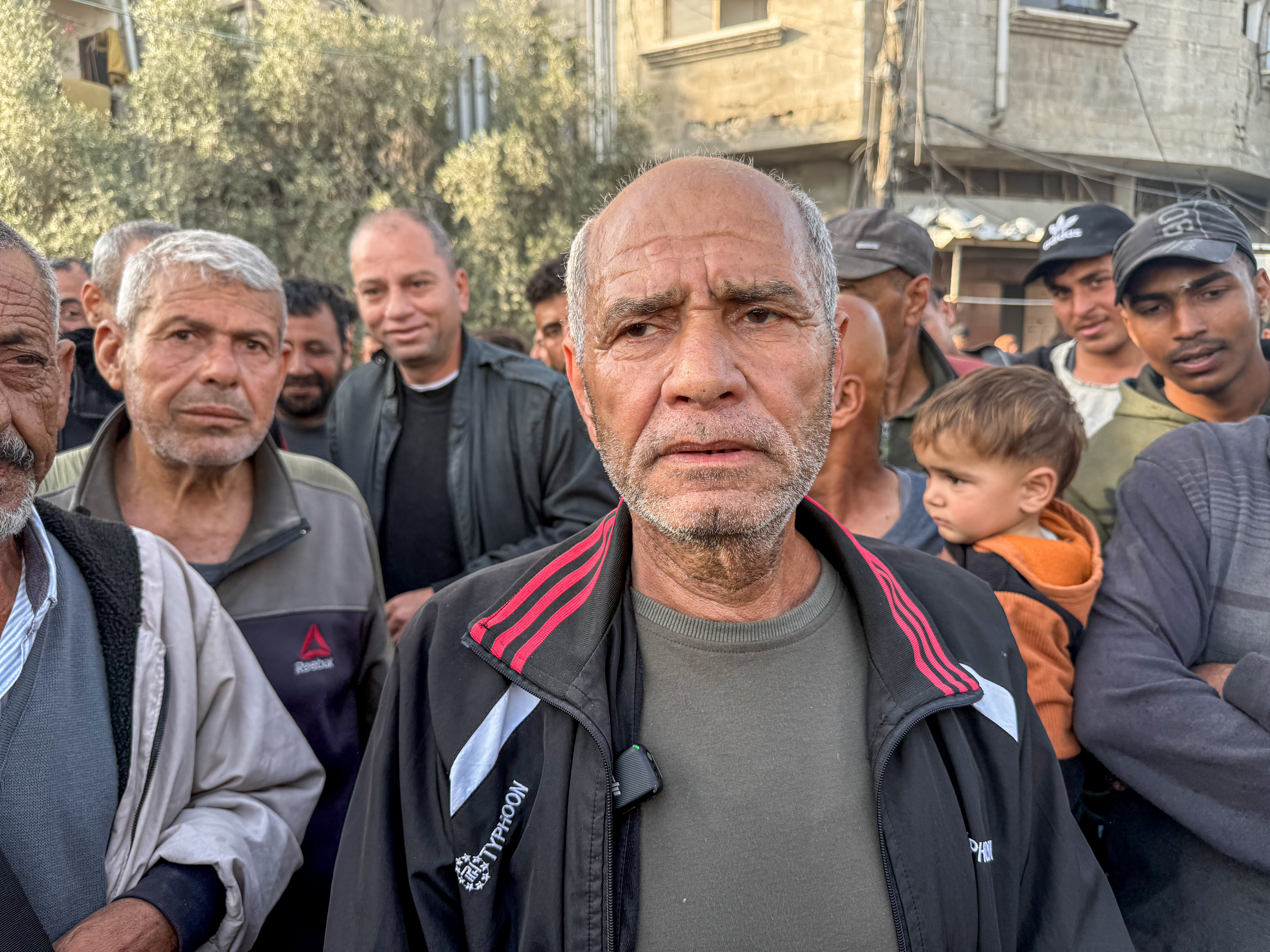 A man in his 50s wearing a light jacket