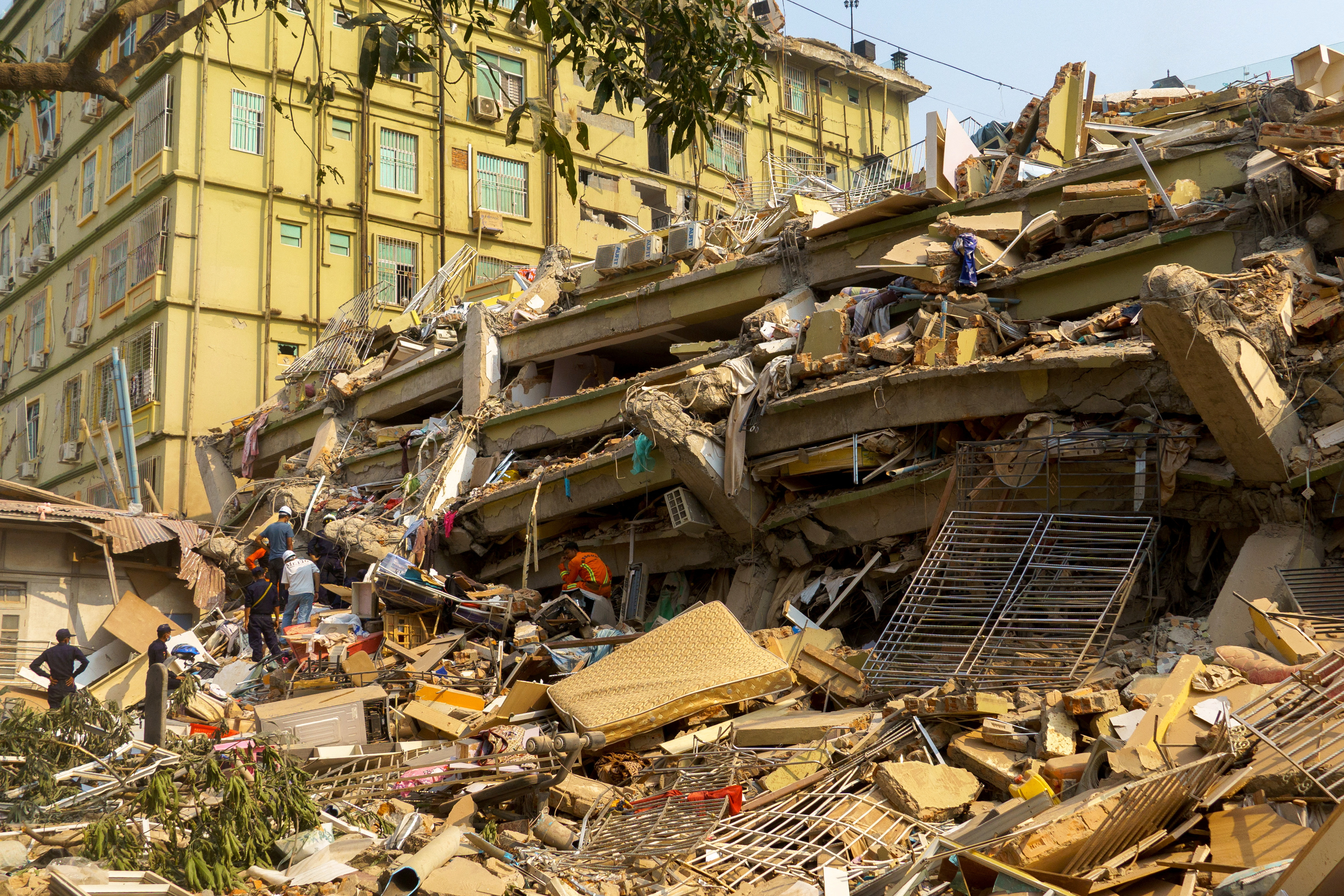 Rescue personnel work at the site of a building that collapsed, following a strong earthquake, in Mandalay, Myanmar, March 29, 2025. REUTERS/Stringer
